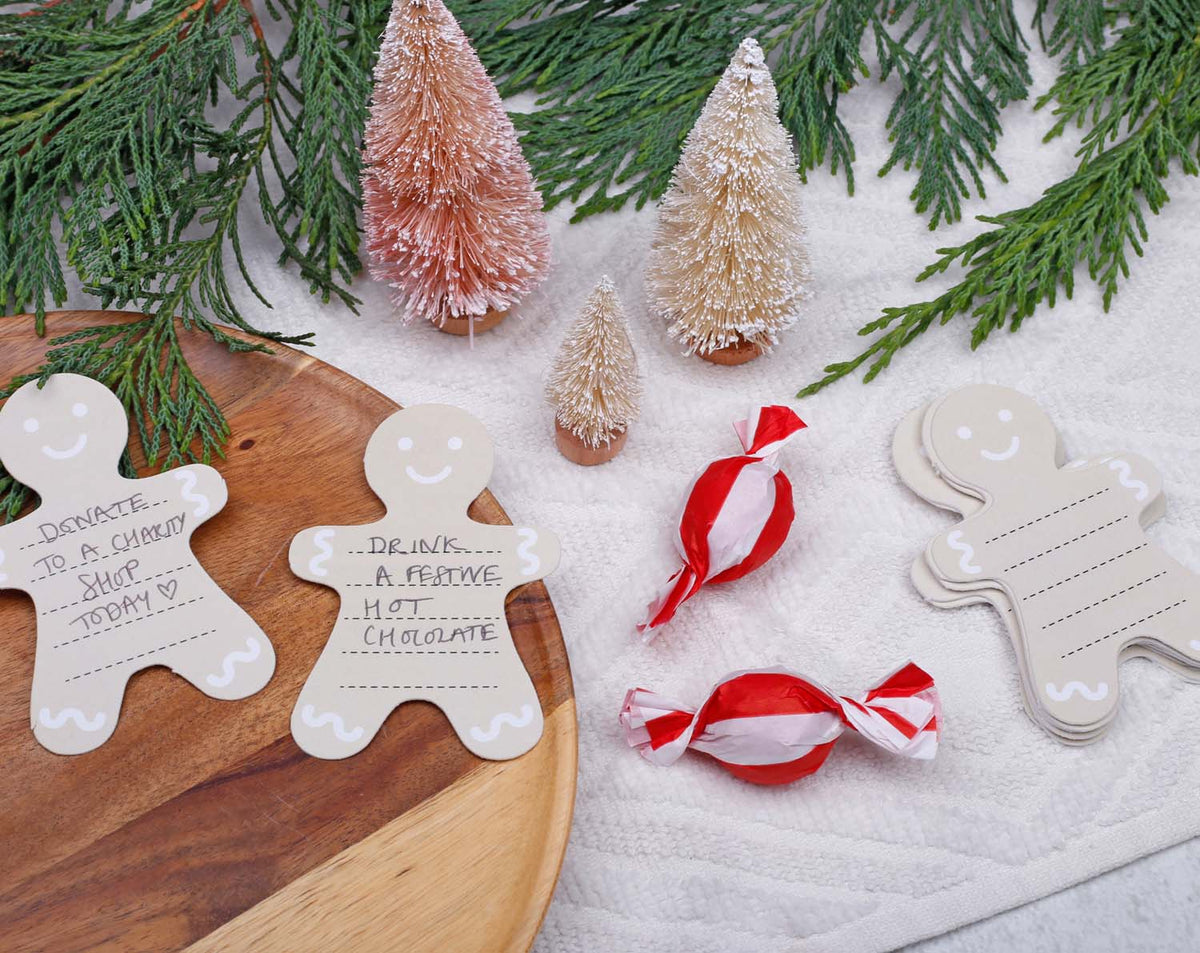 Gingerbread Fill Your Own Activity Cards displayed with festive decorations and sweets for holiday fun.