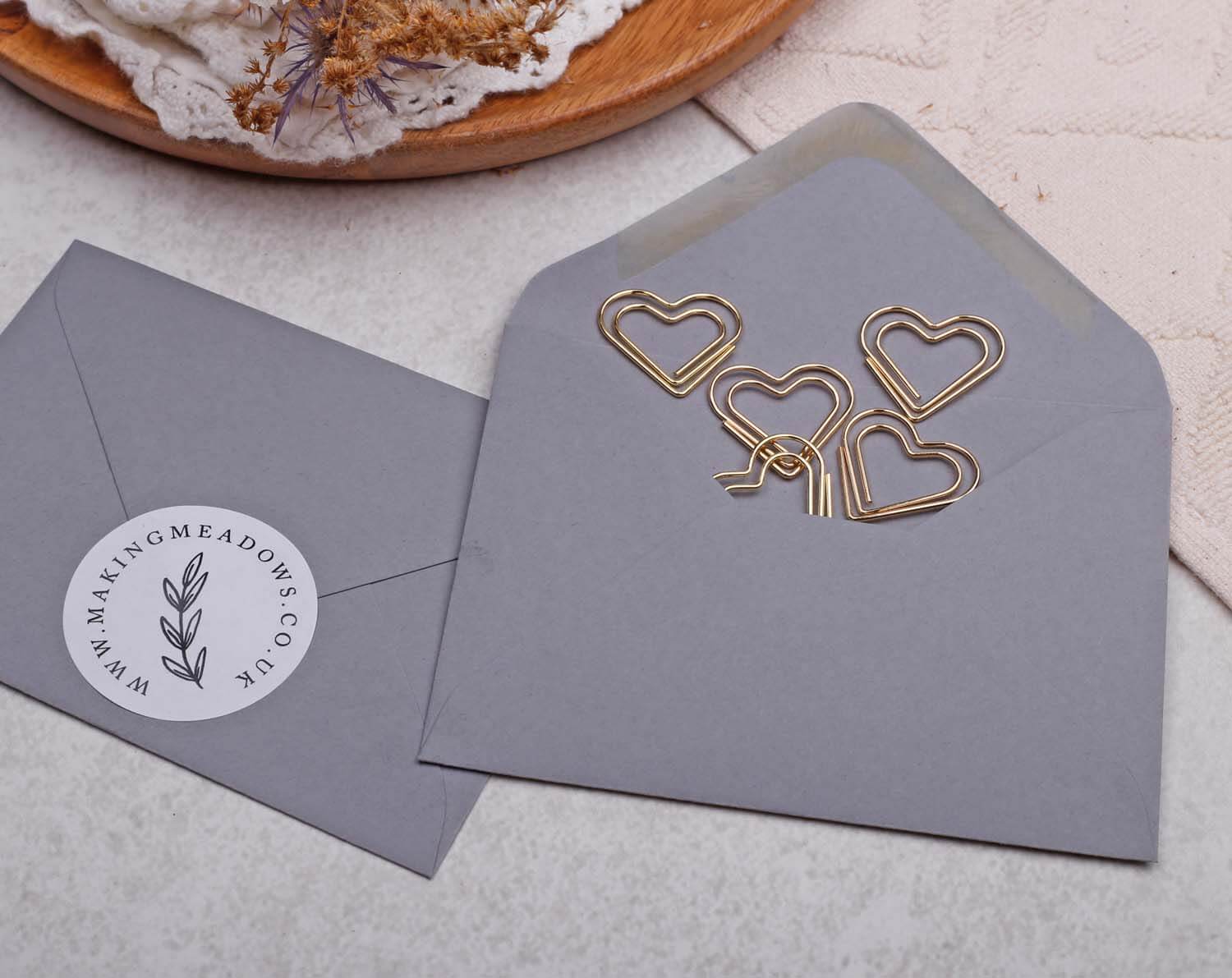 Gold Heart Paper Clips arranged beautifully inside a stylish grey envelope.