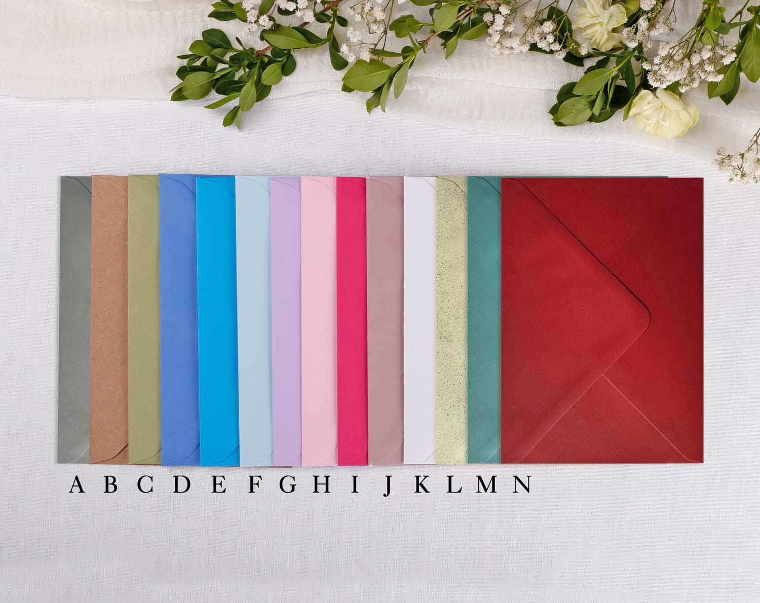 A colourful array of envelopes for Wedding Save The Date cards, showcasing various shades and textures.