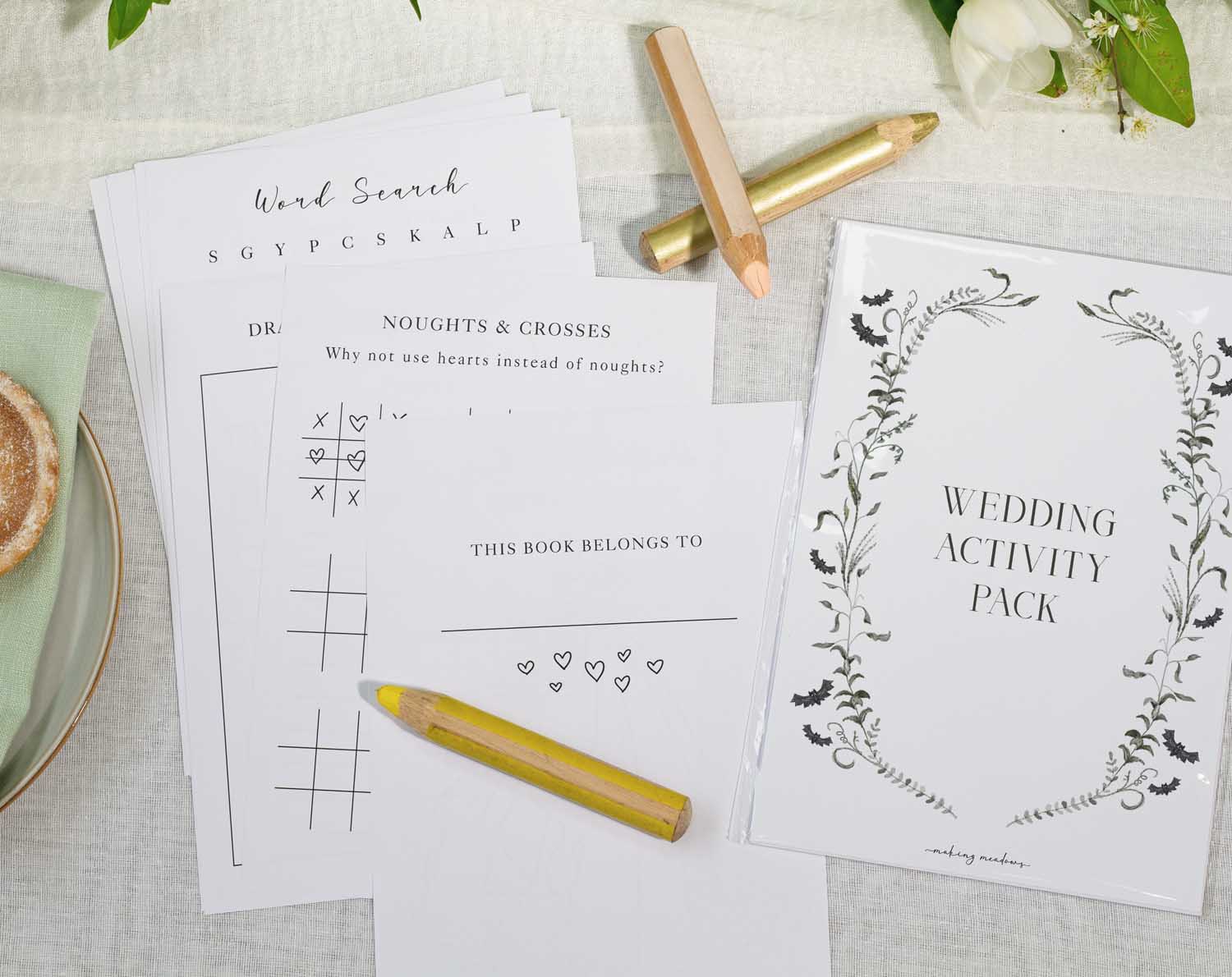 Gothic Wedding Kids Activity Pack with activity sheets and colored pencils on a wedding table.