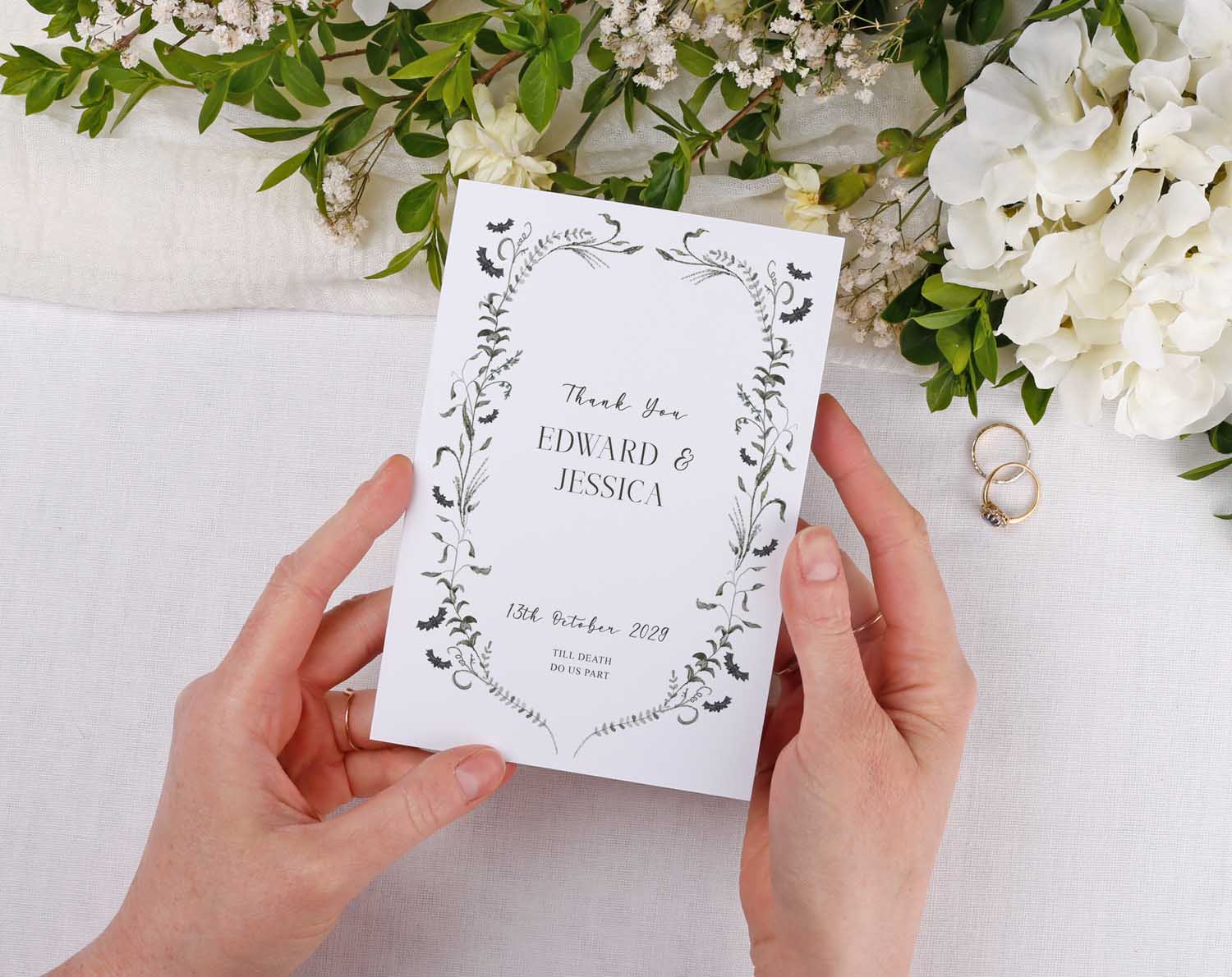 Gothic Wedding Thank You Cards held by hands, featuring floral design and names Edward & Jessica with wedding date.
