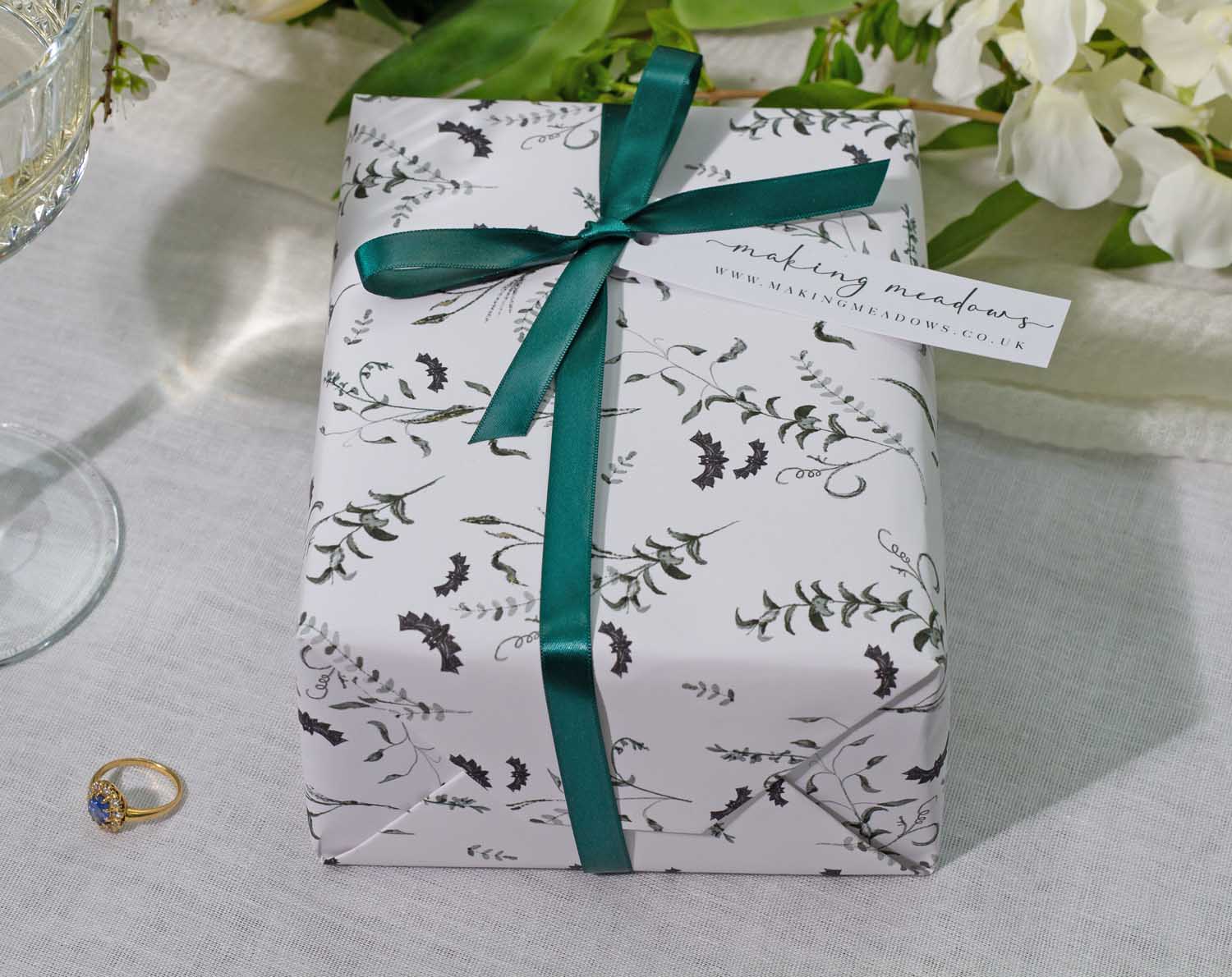 Elegant gift wrapped in Gothic Wedding Wrapping Paper with a teal ribbon, perfect for wedding celebrations.