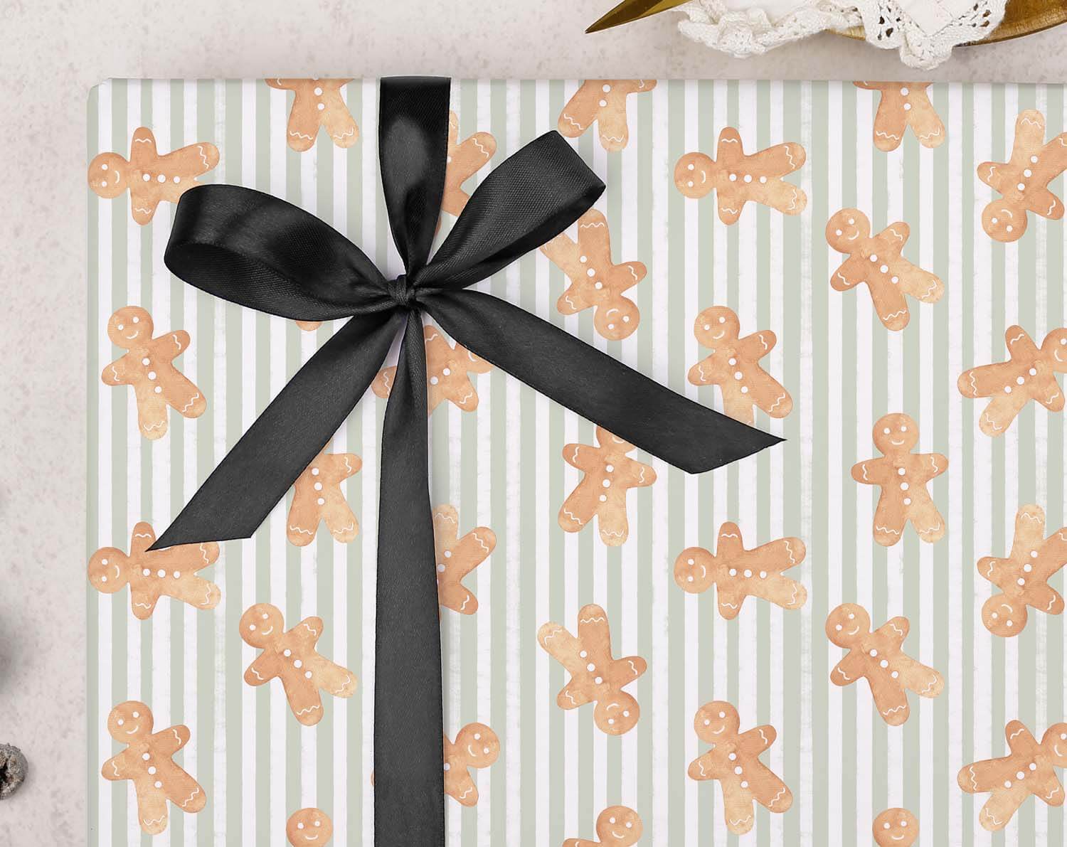 Green Gingerbread Christmas Wrapping Paper featuring gingerbread patterns and a black ribbon bow.