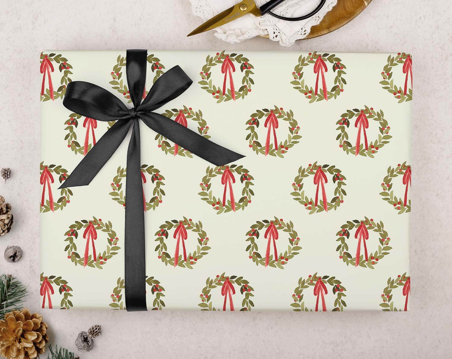 Green Wreath Christmas Wrapping Paper with holly wreath pattern and red bows on a white background.