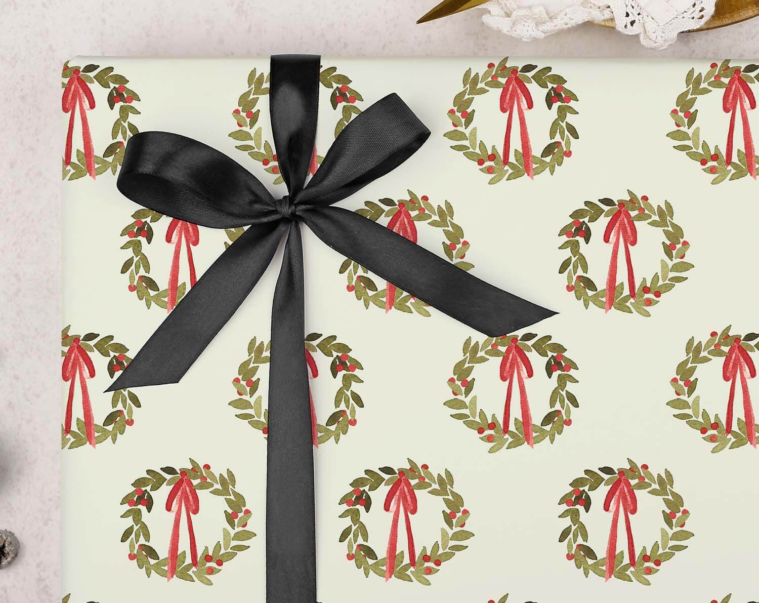 Green Wreath Christmas Wrapping Paper features a vintage holly wreath design with red bows on a muted green background.