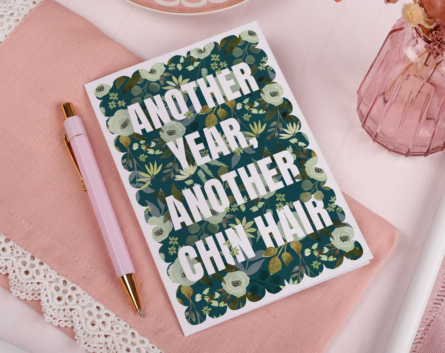 Joke Birthday Card featuring bold text and floral background about chin hair, perfect for a humorous birthday greeting.