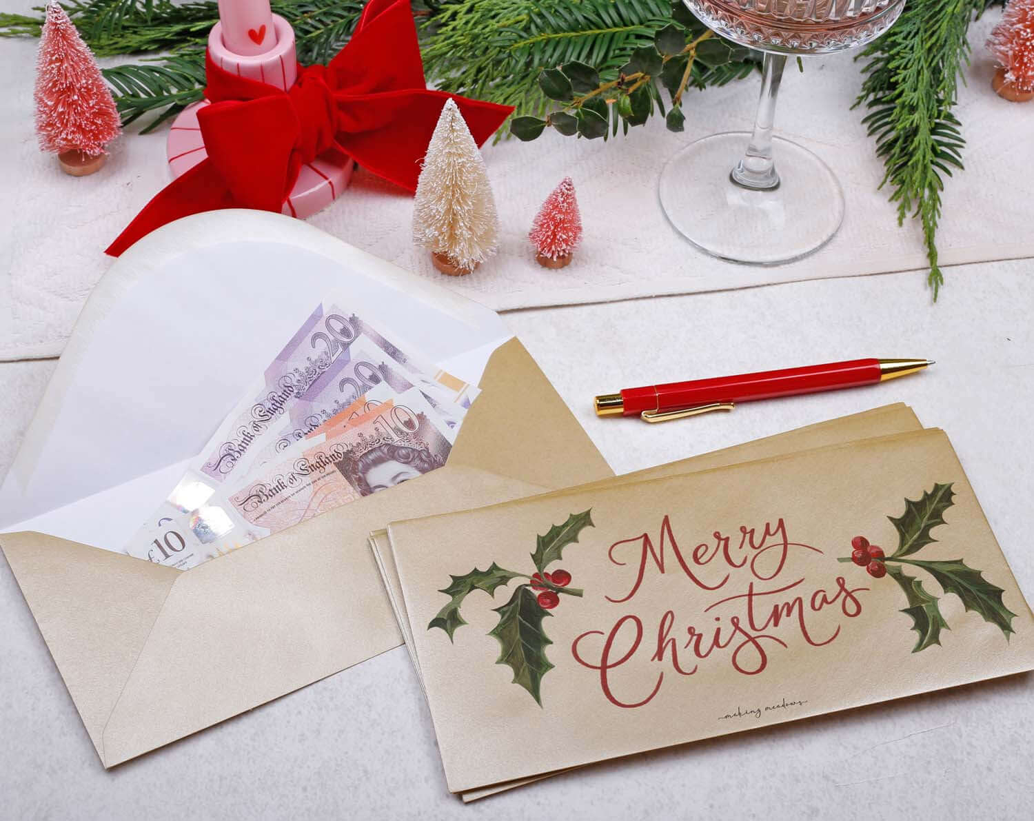 Holly Christmas Money Envelopes in gold, featuring merry Christmas greeting and holly illustrations, perfect for festive gifting.