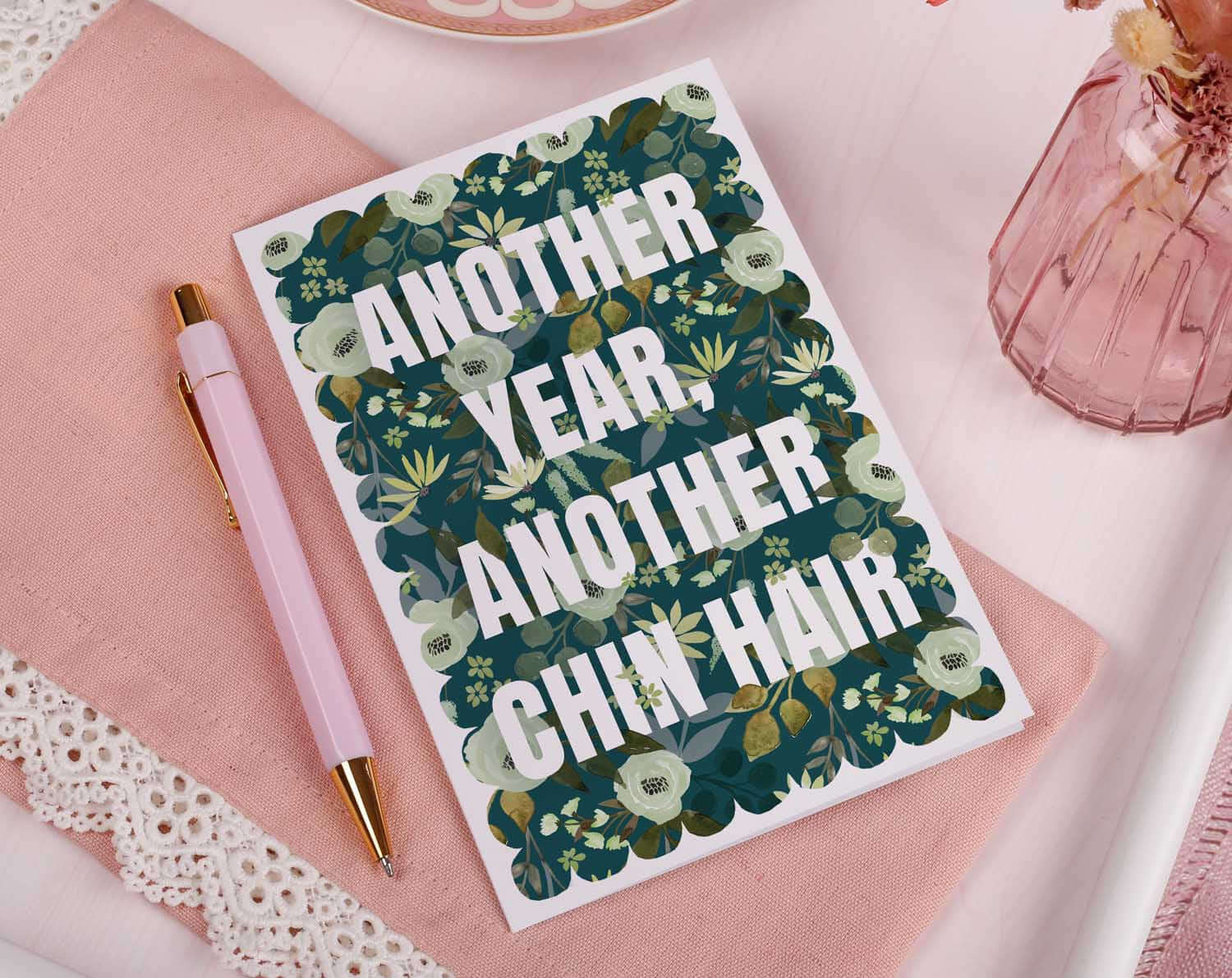 Joke Birthday Card featuring bold text and floral background about chin hair, perfect for a humorous birthday greeting.