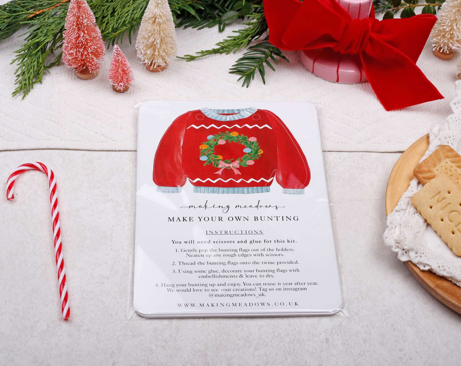 Jumper Christmas Bunting instructions card featuring a red sweater design with a wreath for festive decorations.