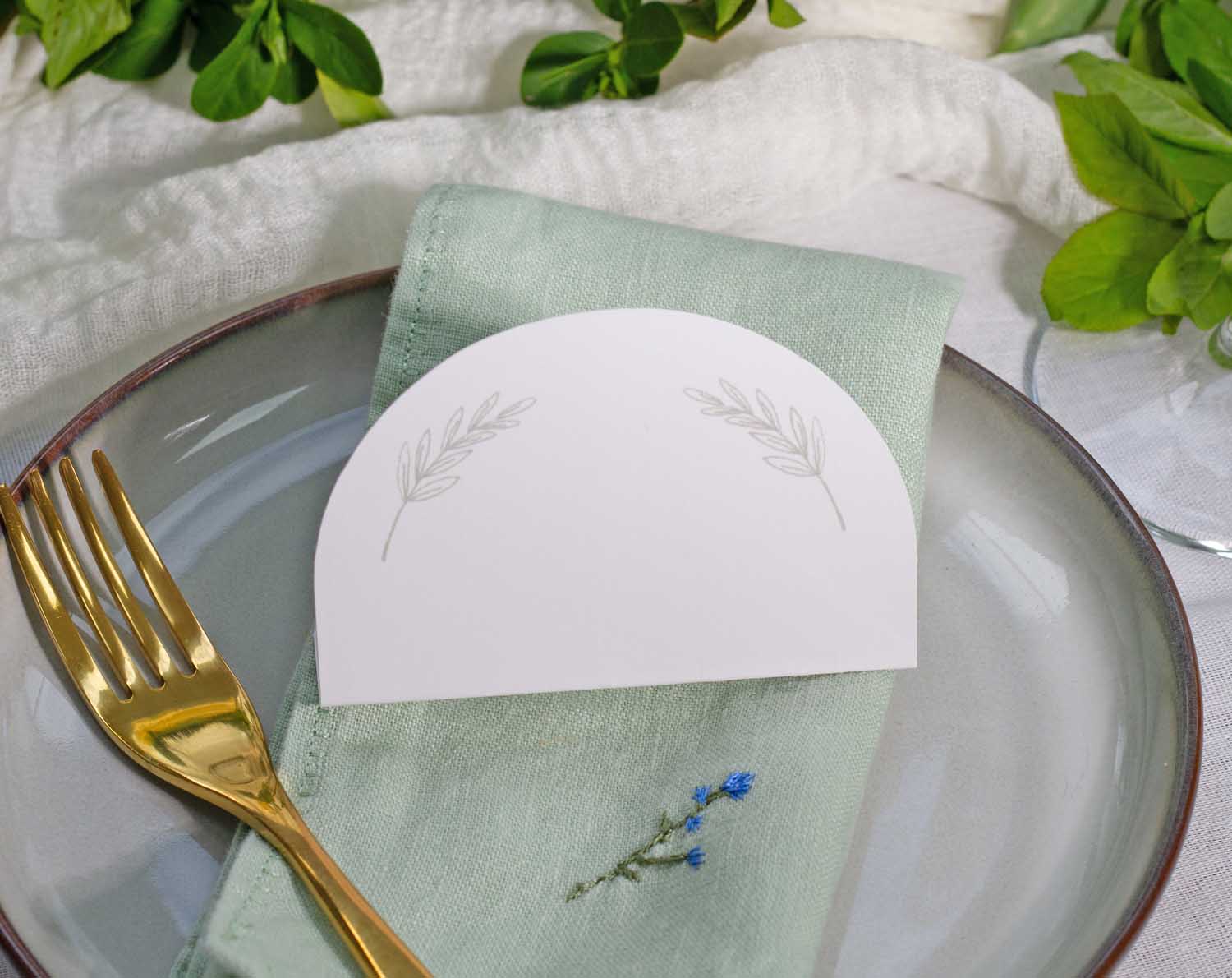 Minimalist Wedding Place Cards elegantly displayed on a dining plate with a fork and napkin.