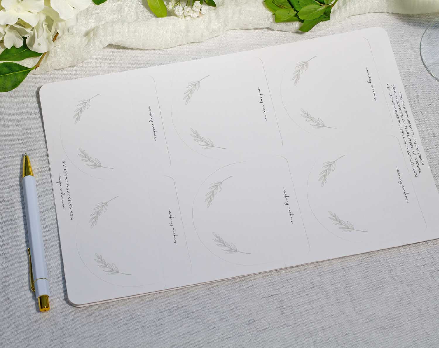 Minimalist Wedding Place Cards design featuring delicate leaf illustrations on a clean white background.