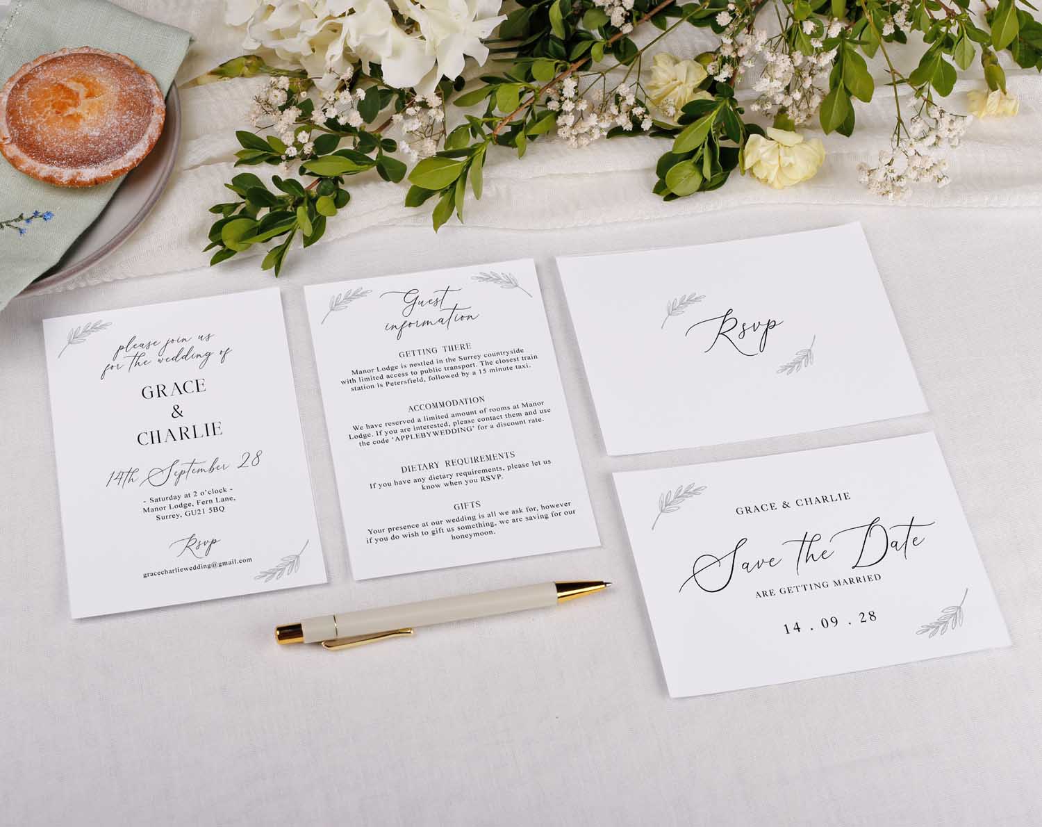 Minimalist Wedding RSVP Cards displayed with other wedding stationery and floral decorations on a table.