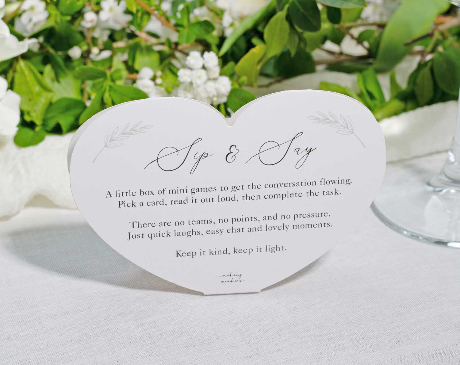 Minimalist Wedding Table Game Sip & Say card with instructions for interactive wedding fun.