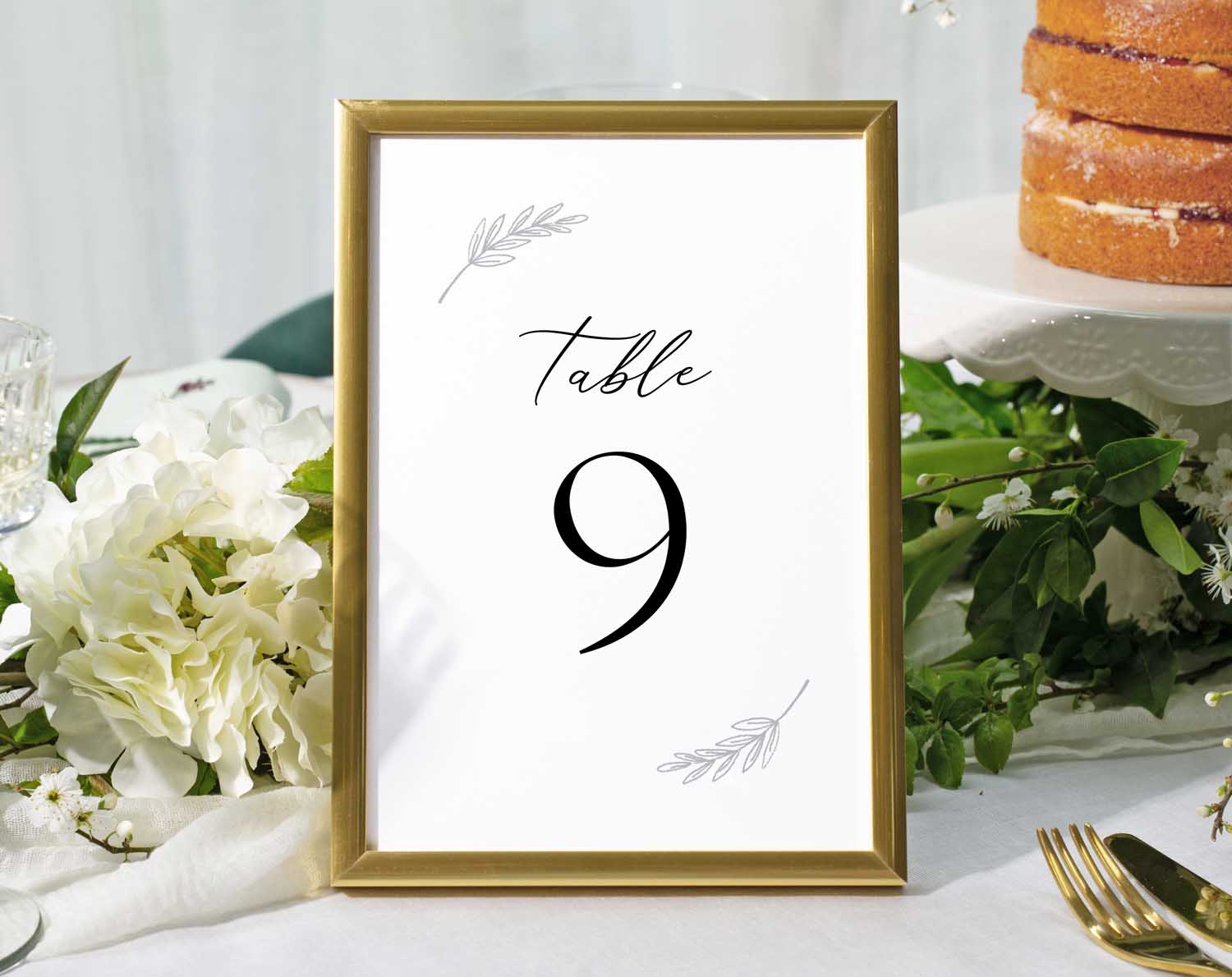 Minimalist Wedding Table Numbers in a gold frame displaying Table 9 at a beautifully arranged reception table.