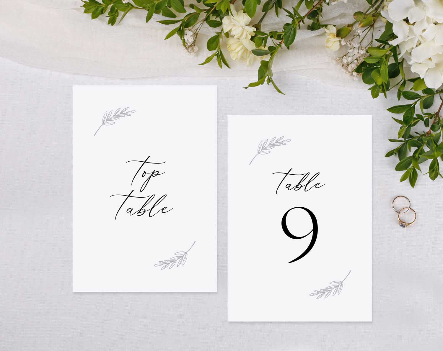 Minimalist Wedding Table Numbers displayed on a reception table with floral accents.