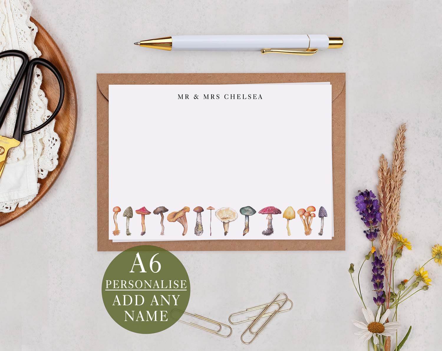 Mushroom Personalised Note cards with whimsical illustrations on a kraft envelope and pen.