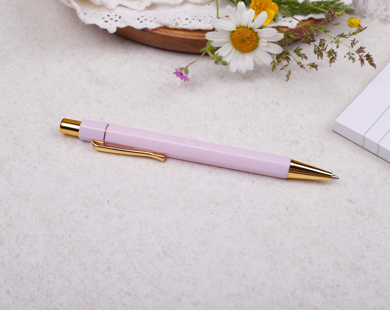 light pink and gold ballpoint pen with black ink