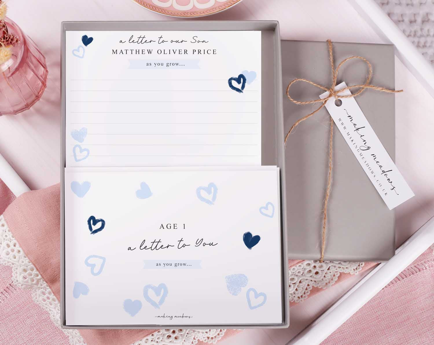 Personalised Blue Heart Letter To Our Son in a gift box with heart designs and writing paper.