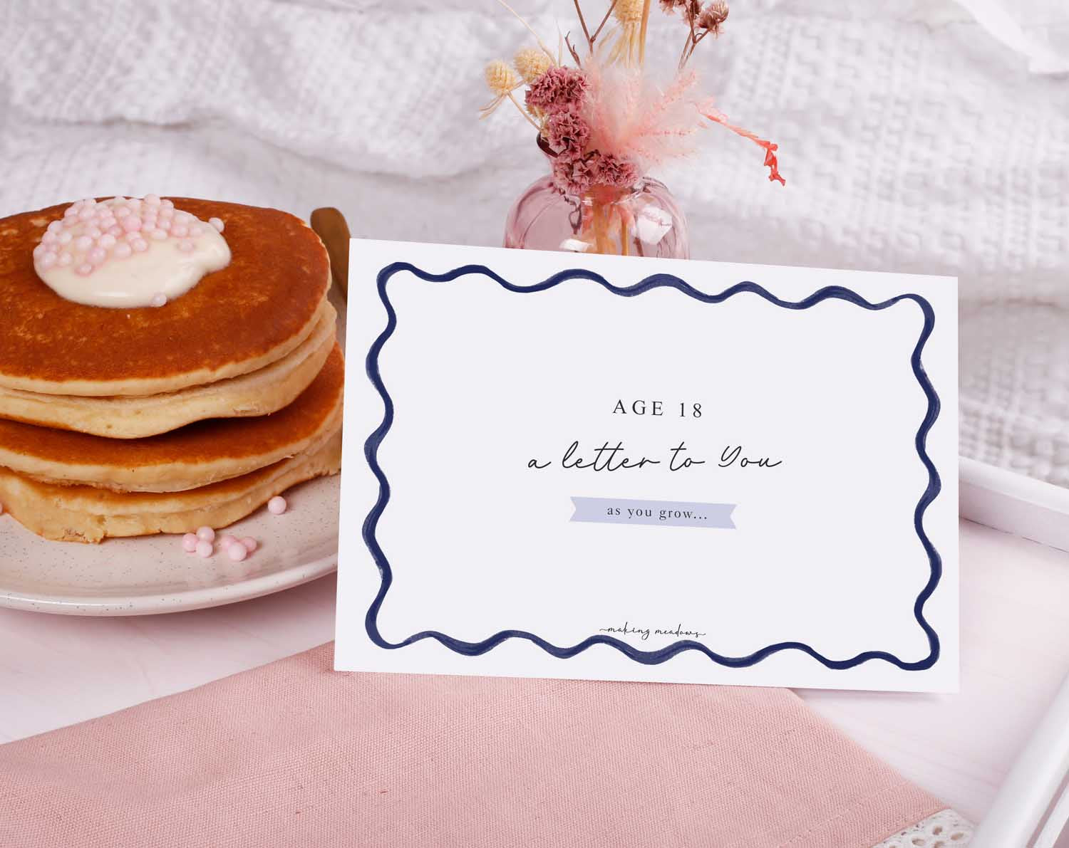 Personalised Blue Wavy Letter To Our Son displayed on a table with pancakes and decor.