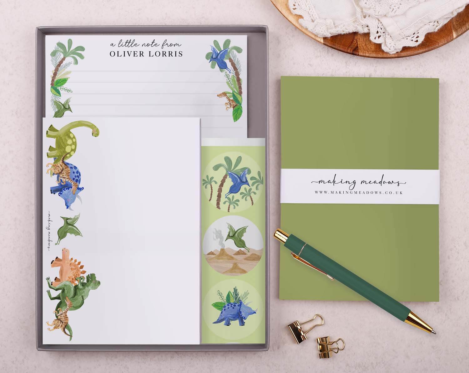 Personalised Children's Stationery Set featuring dinosaur designed writing paper, envelopes, and a luxury pen.