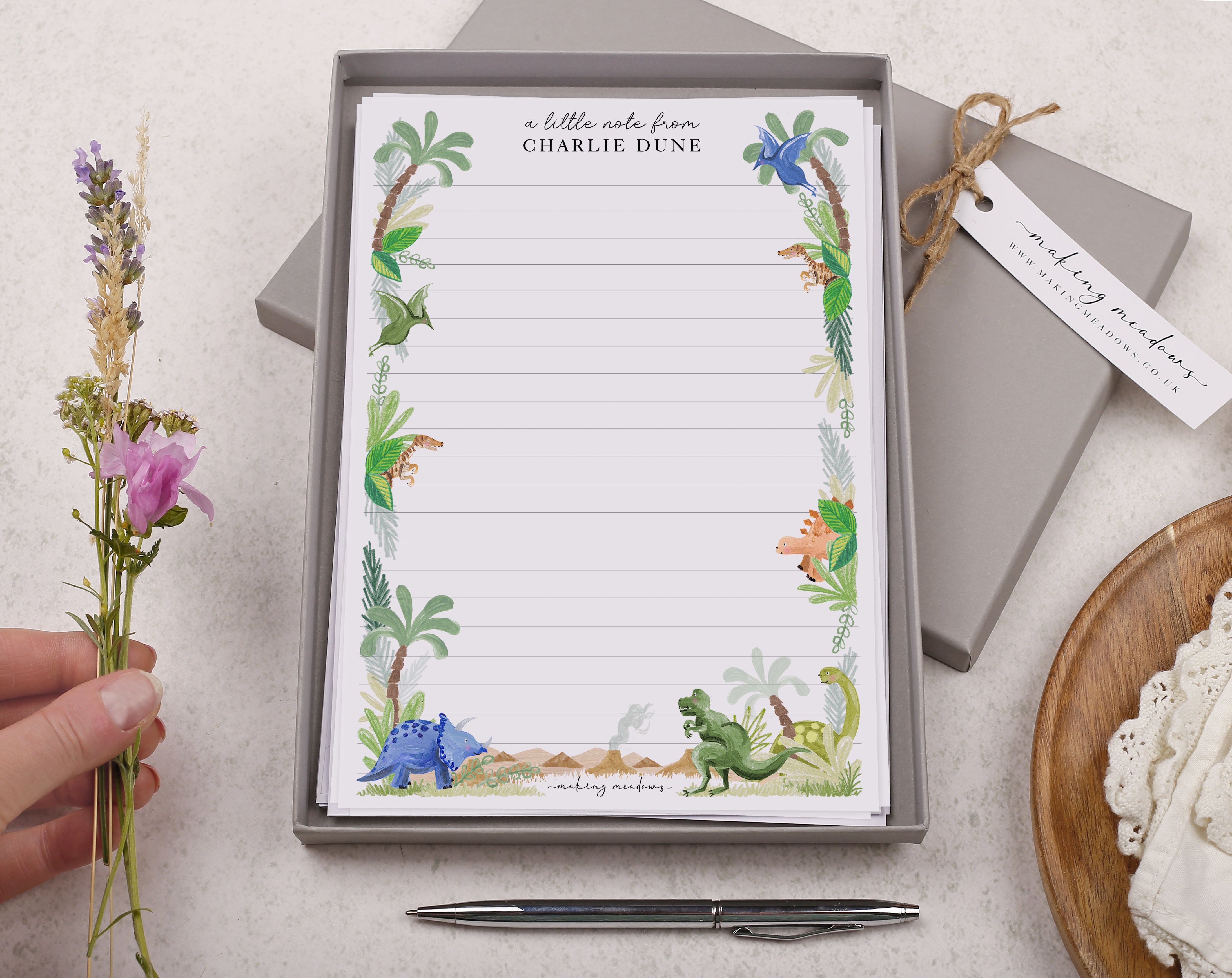 Premium personalised A5 letter writing paper set for children with a cute dinosaur in the jungle design.