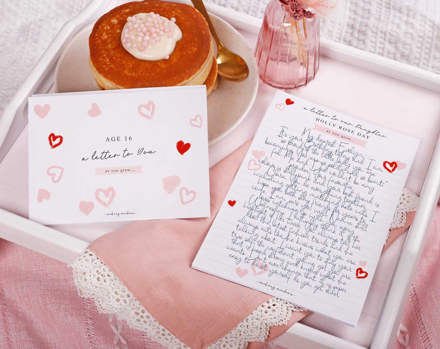 Personalised Pink Heart Letter To Our Daughter displayed with pancakes and delicate decor.