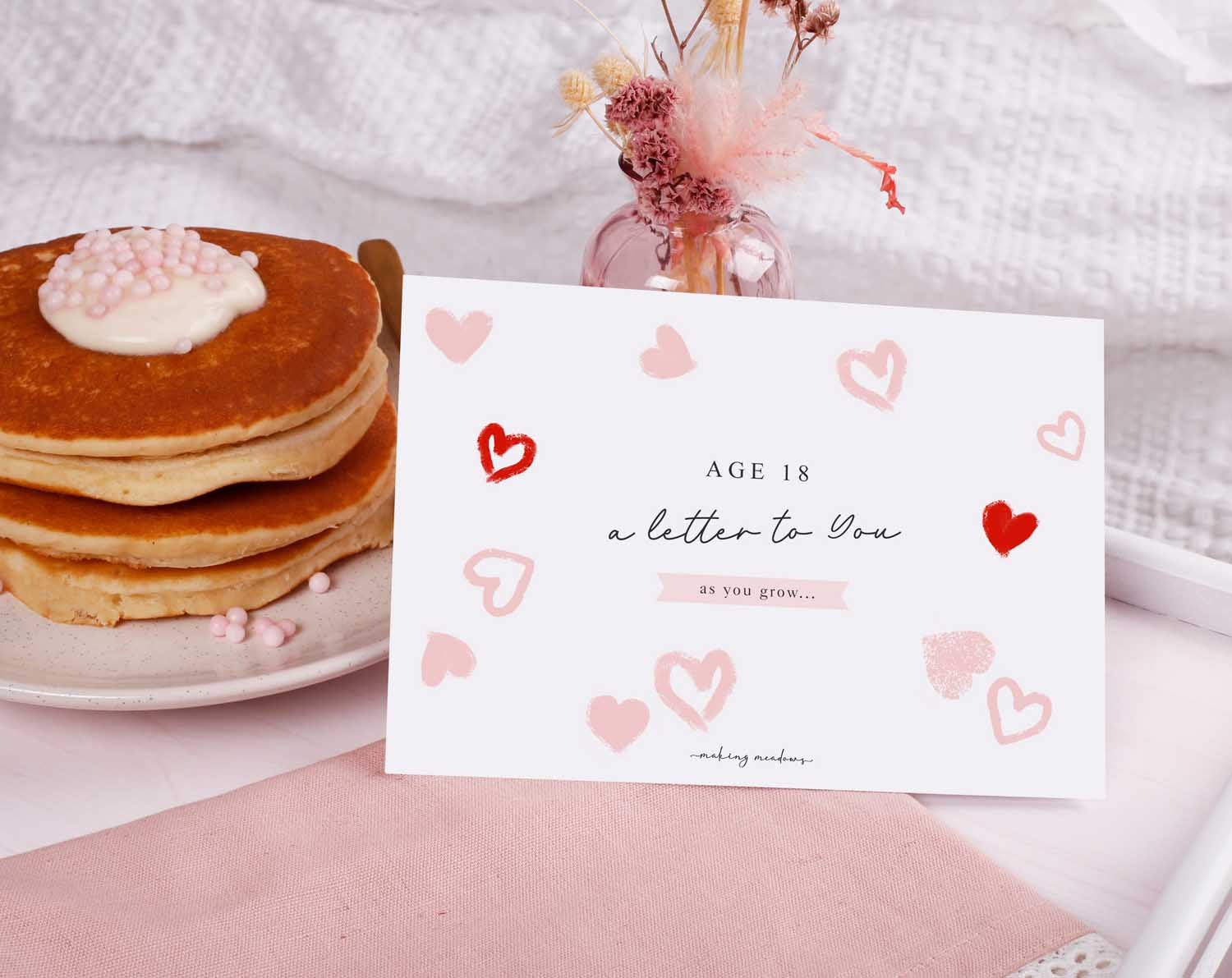 Personalised Pink Heart Letter To Our Daughter displayed with pancakes and decorative pink elements.