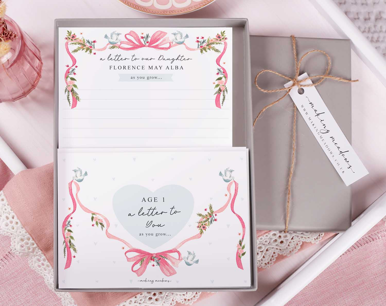 Personalised Vintage Letter To Our Daughter set in a decorative box with floral designs and ribbons.