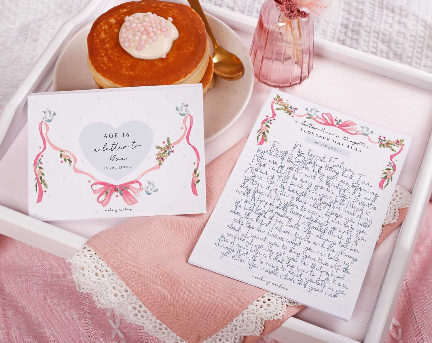 Personalised Vintage Letter To Our Daughter displayed with a pancake and floral vase on a tray