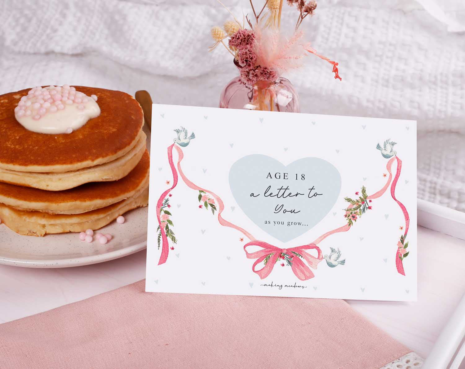 Personalised Vintage Letter To Our Daughter displayed with pancakes and a pink backdrop.