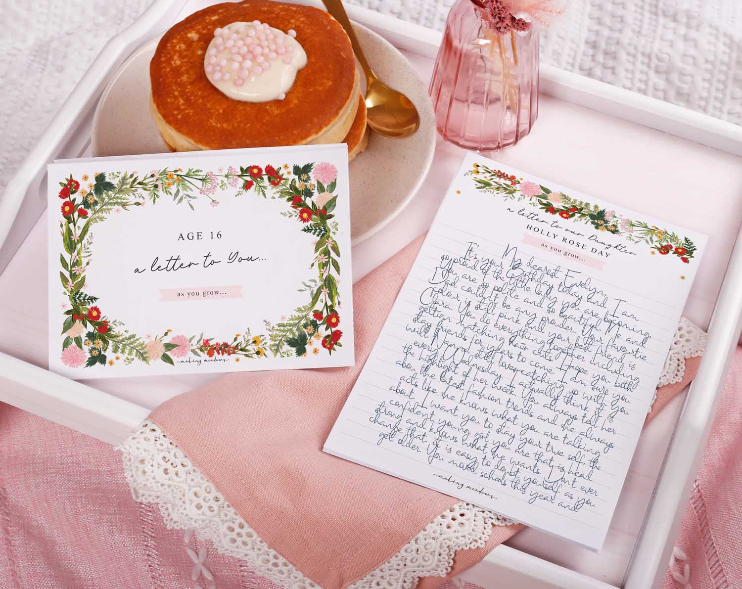 Personalised Wild Floral Letter To Our Daughter set displayed with cake and floral decor.