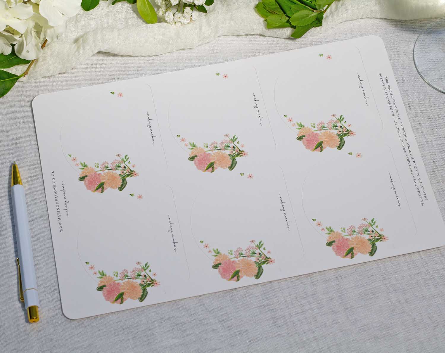 Pink Floral Wedding Place Cards displayed on a table, featuring delicate pink blooms for a romantic touch.