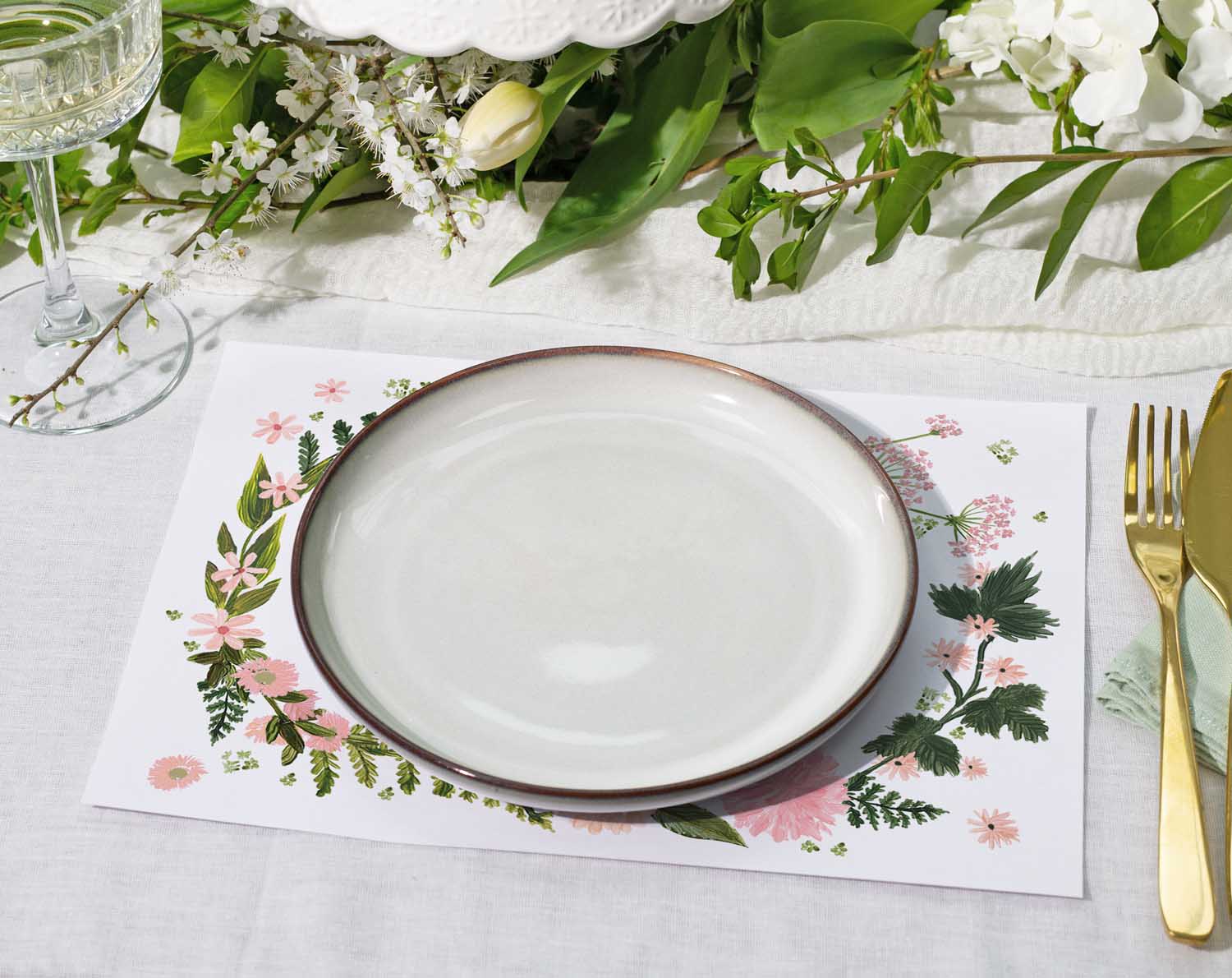 Pink Floral Wedding Placemats with a white plate and greenery for elegant table setting