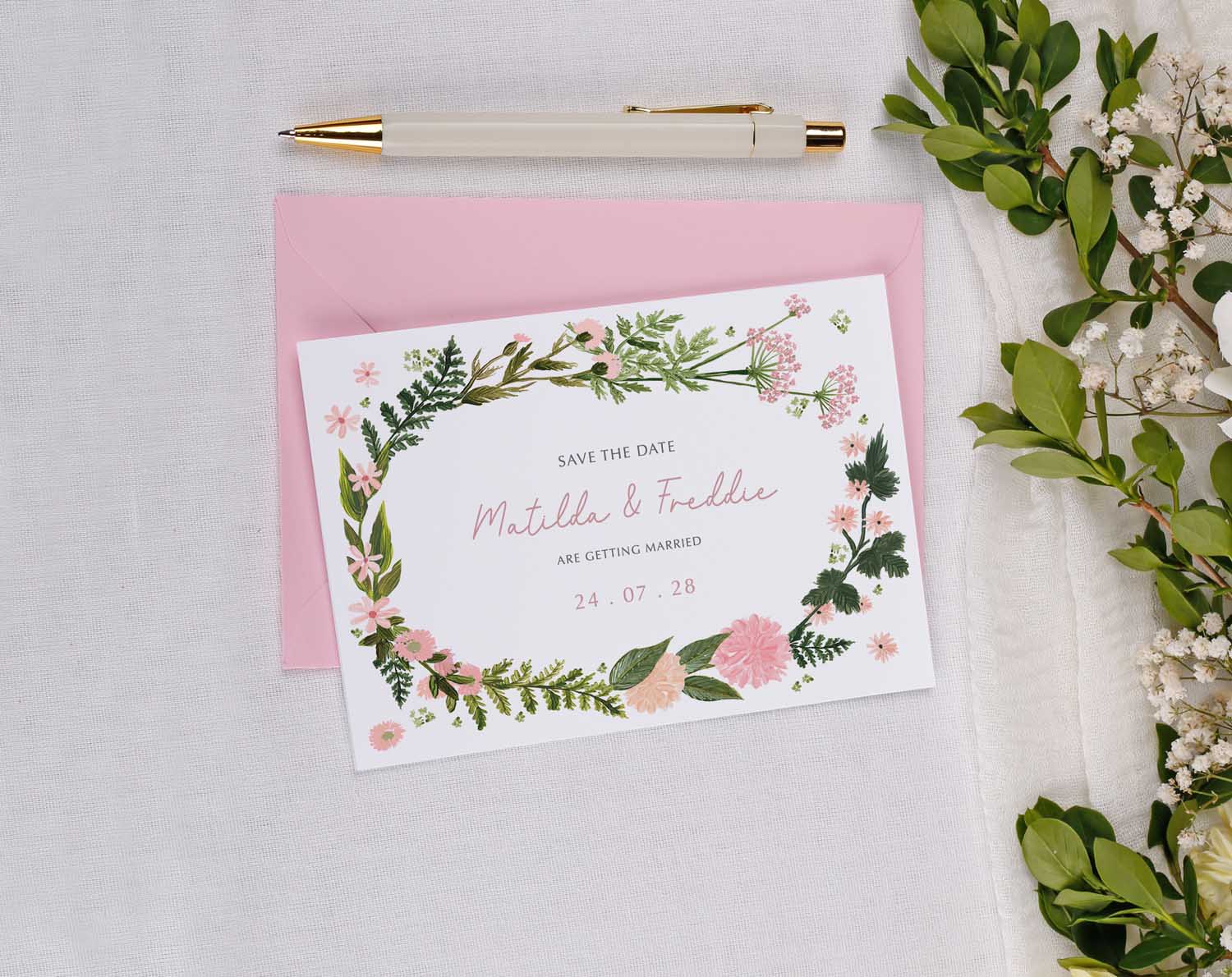 Pink Floral Wedding Save The Date card featuring a floral design with greenery and pastel colors.