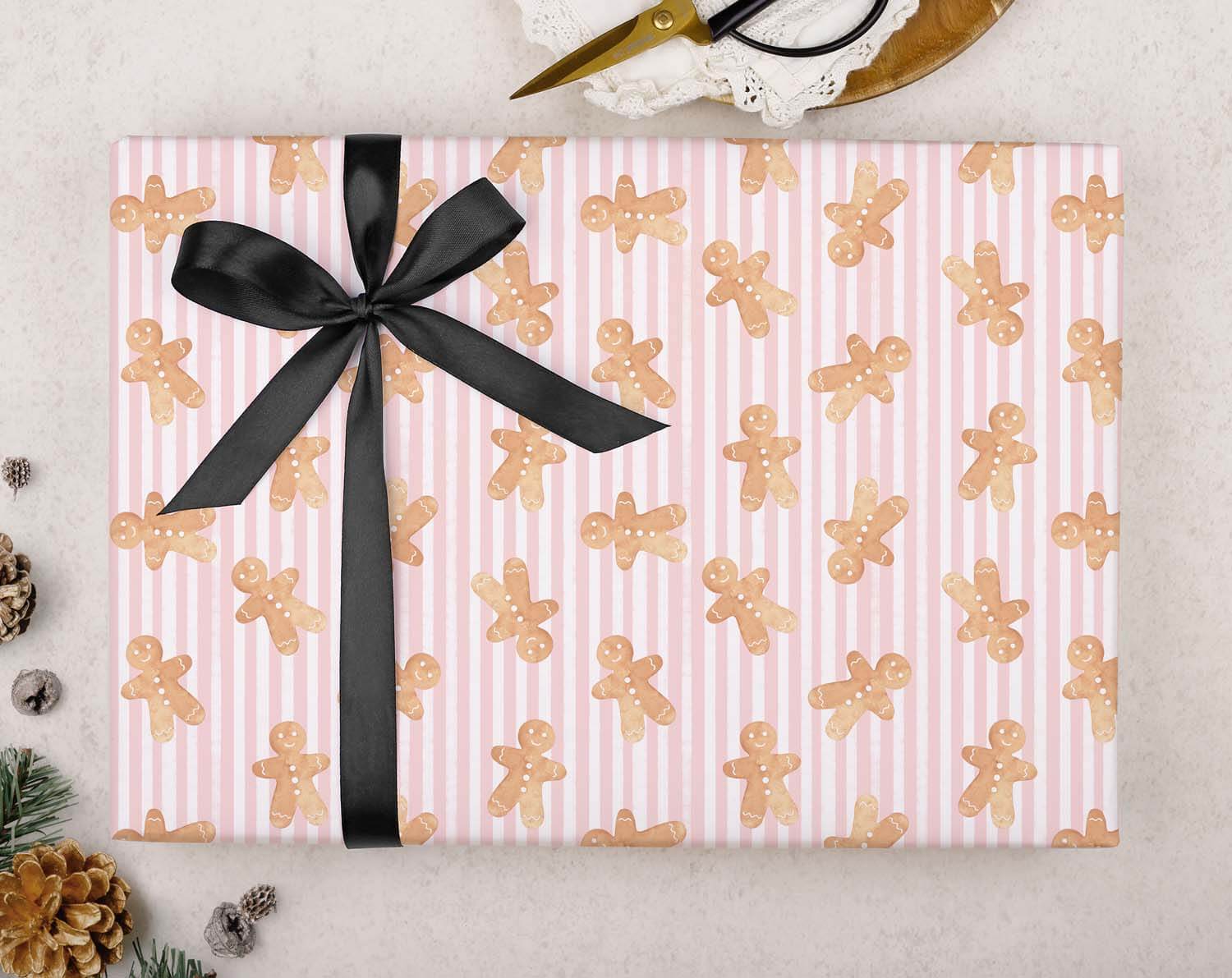 Pink Gingerbread Christmas Wrapping Paper with black ribbon, featuring gingerbread man pattern for festive gifts, Driving Home Christmas Wrapping Paper.