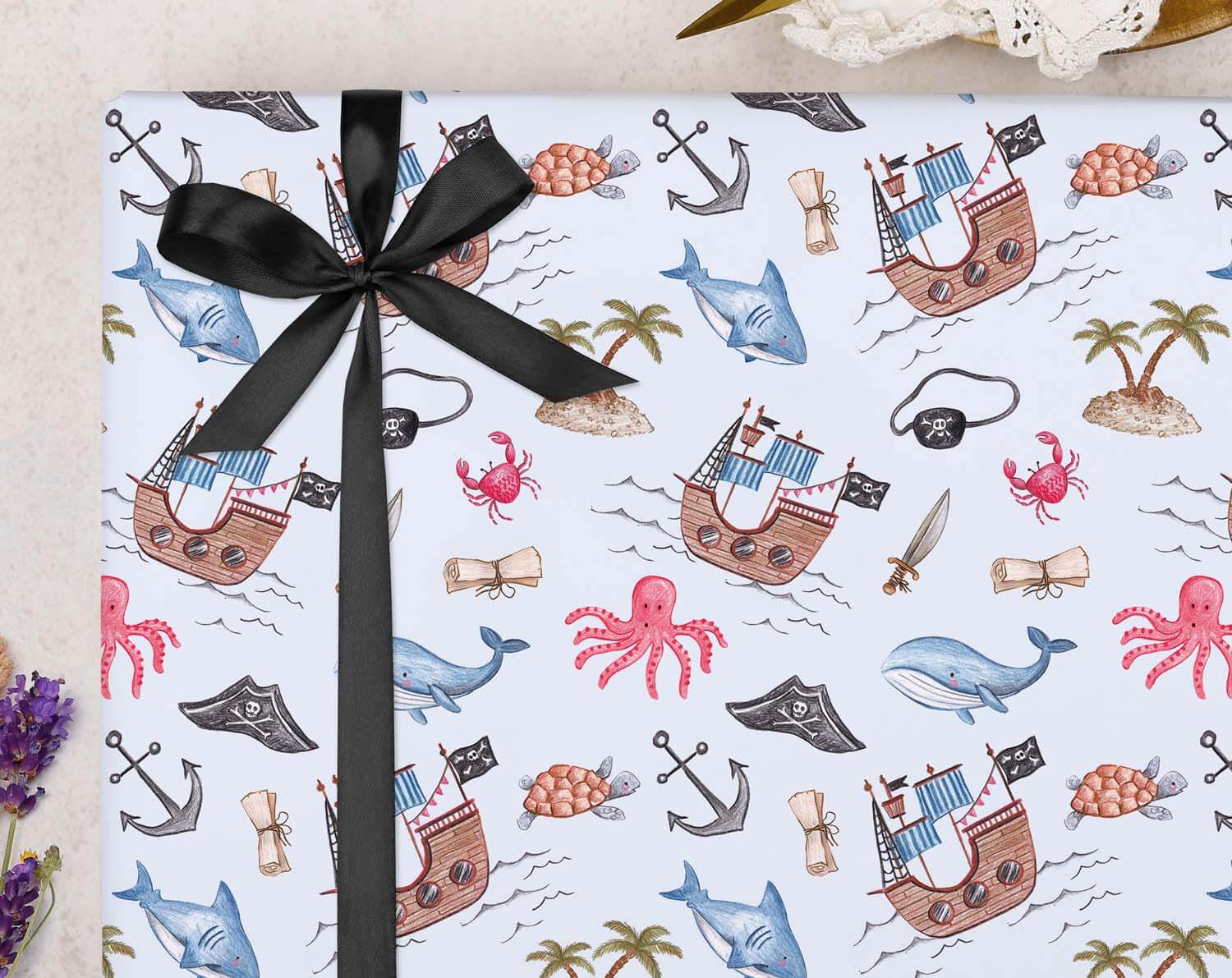 Pirate Birthday Wrapping Paper with fun pirate patterns, sea creatures, and black ribbon for exciting gift presentation.
