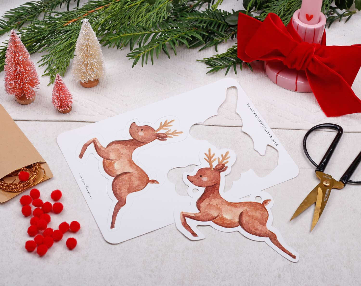 Reindeer Christmas Bunting artwork featuring playful reindeers on a crafting background with holiday decorations.