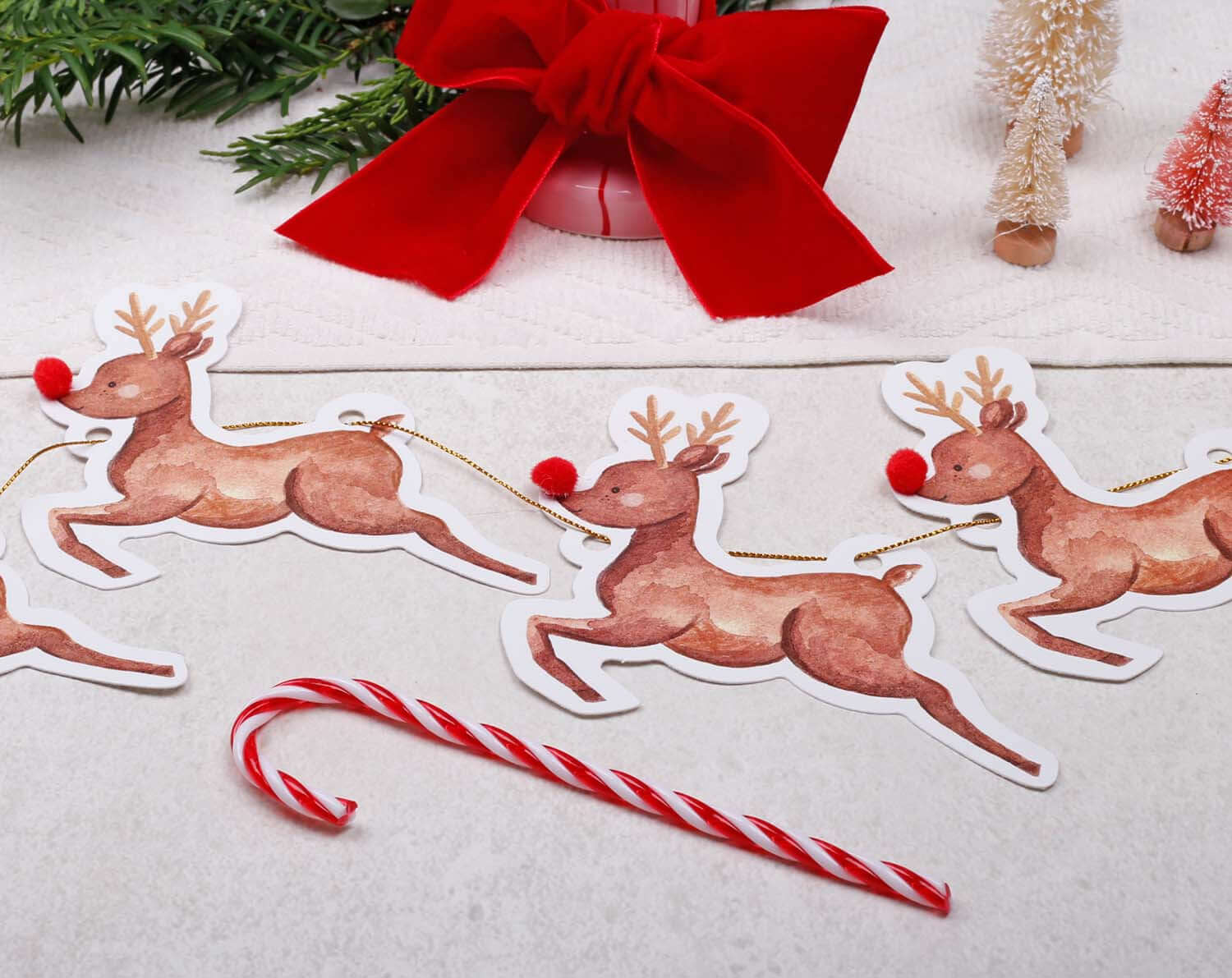 Reindeer Christmas Bunting featuring playful reindeer flags with red pom-poms, ideal for festive decorations.