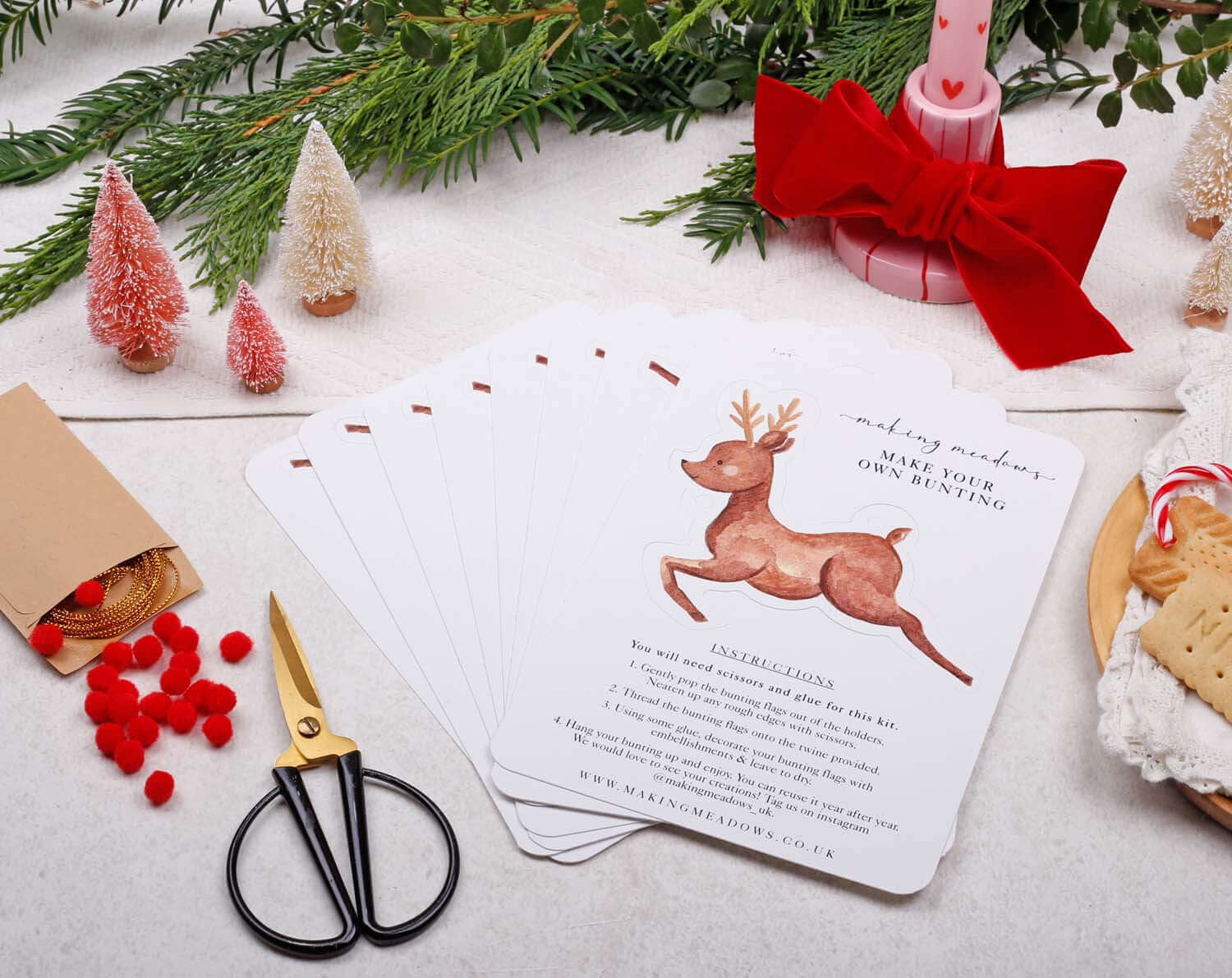 Reindeer Christmas Bunting instructions with playful reindeer design and crafting supplies on a festive table.