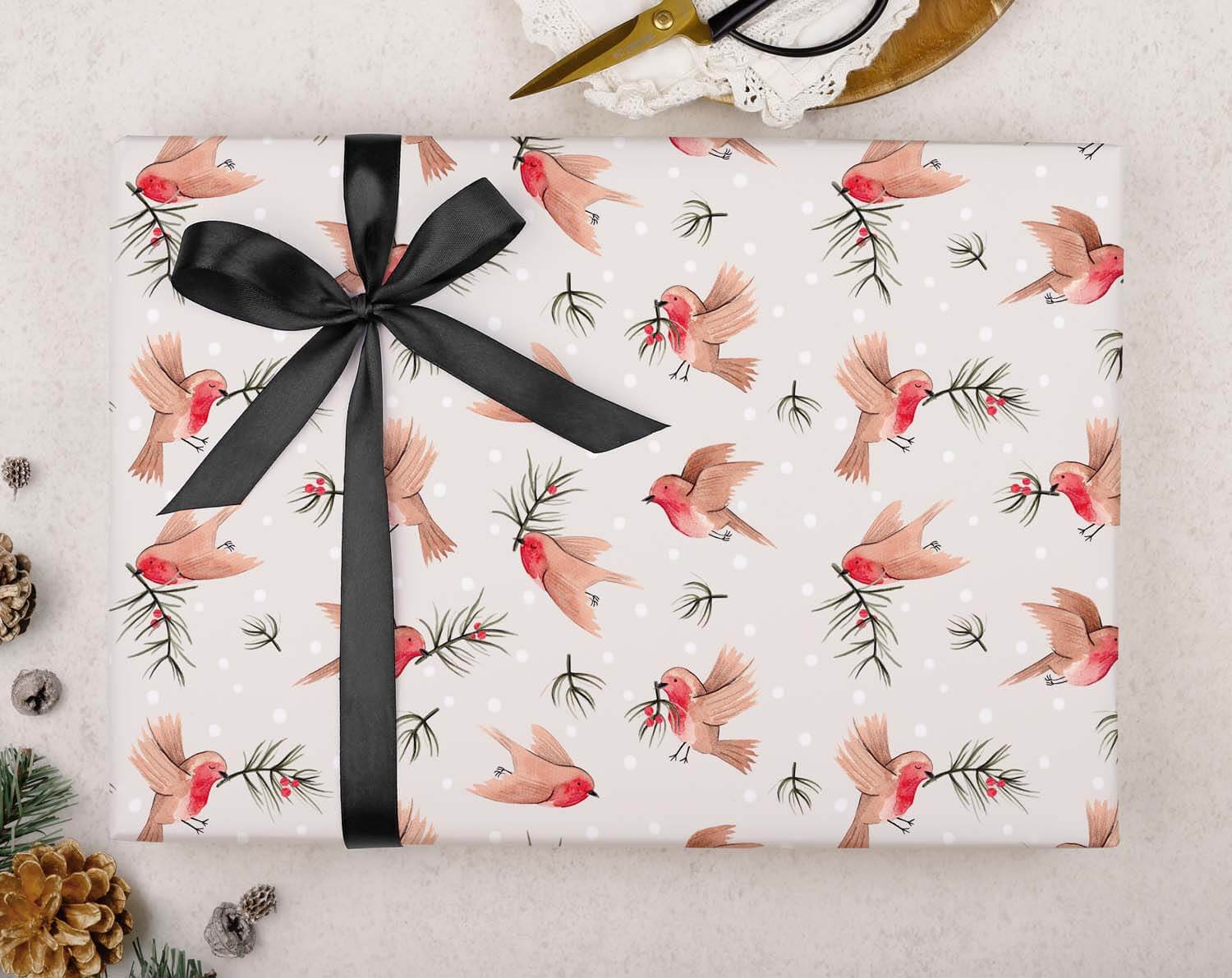 Robin Christmas Wrapping Paper featuring festive robins and black ribbon on a beautifully wrapped gift.