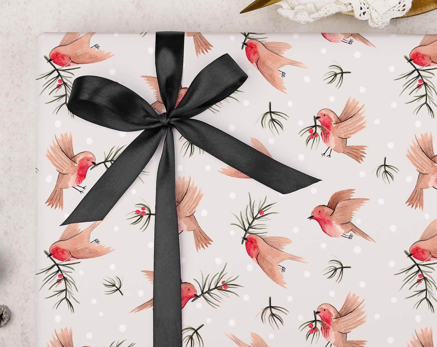 Robin Christmas Wrapping Paper featuring hand-painted robins and pine branches with a black satin ribbon