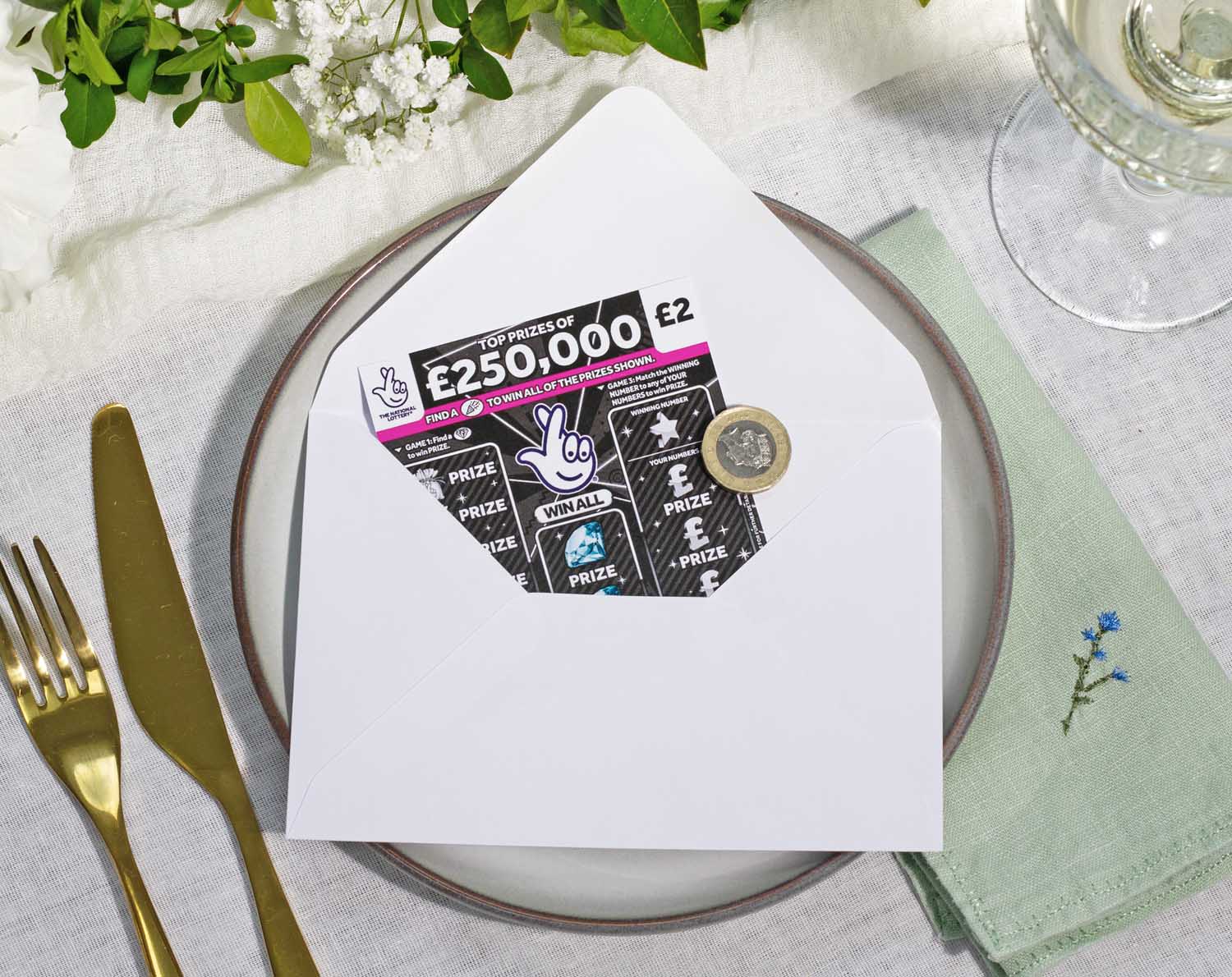 Scratch Card Envelopes placed on a wedding table setting with a scratch card visible inside.