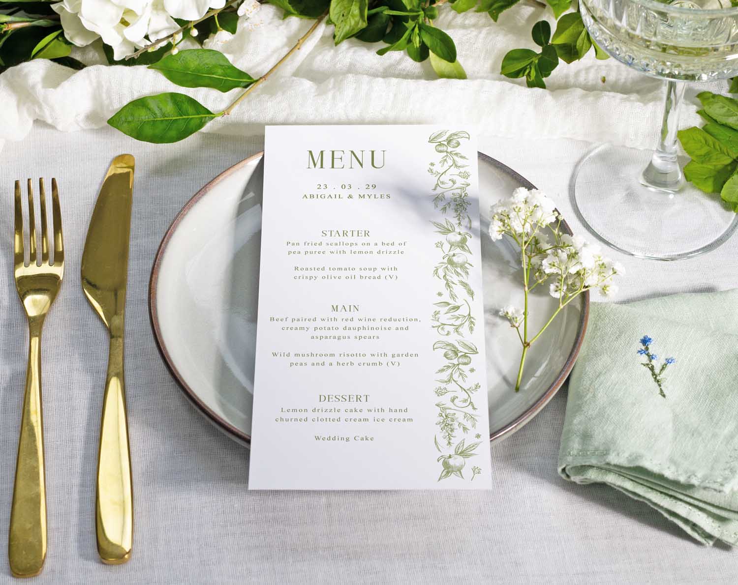 Sage Garden Wedding Menus displayed on a beautifully set table with elegant cutlery and fresh flowers.