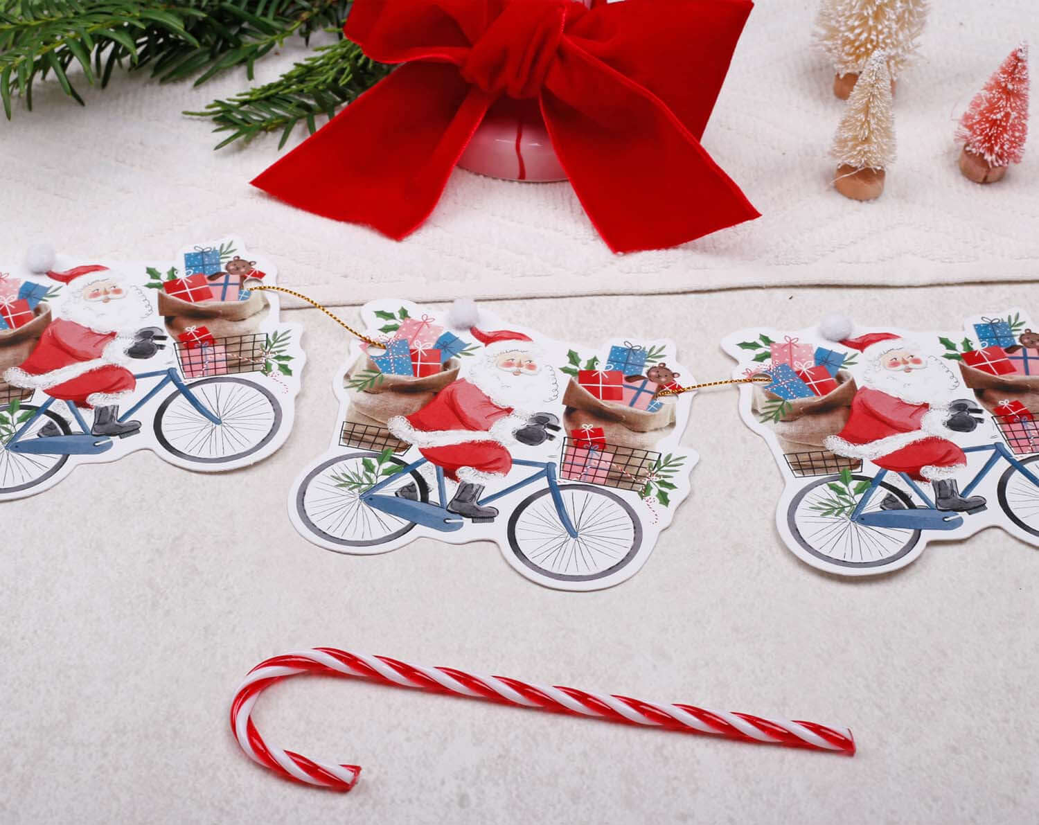 Santa Christmas Bunting featuring Santa on a bicycle with presents, festive decor for Christmas celebrations.