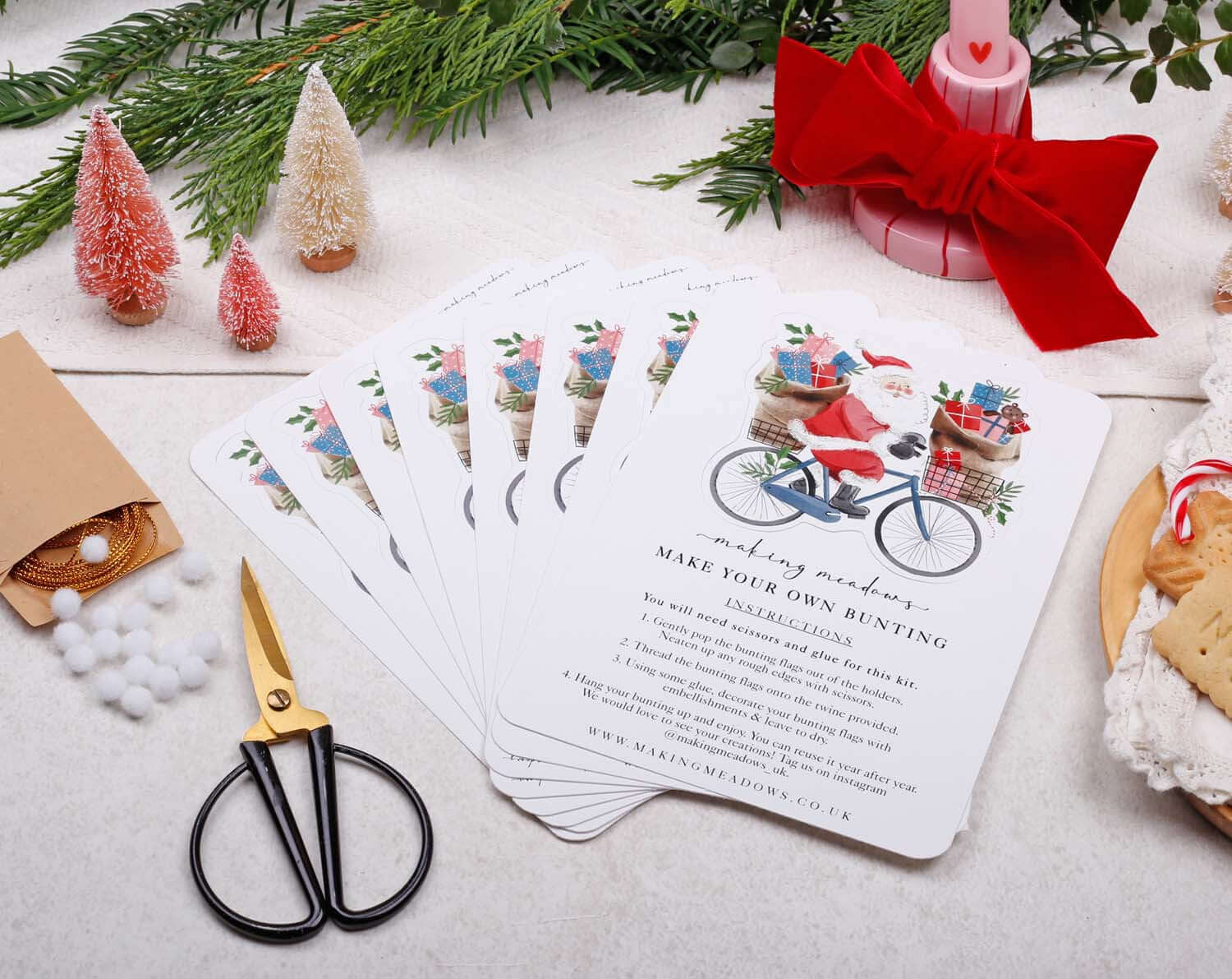 Santa Christmas Bunting DIY kit with cheerful flags and scissors on a festive table setting.
