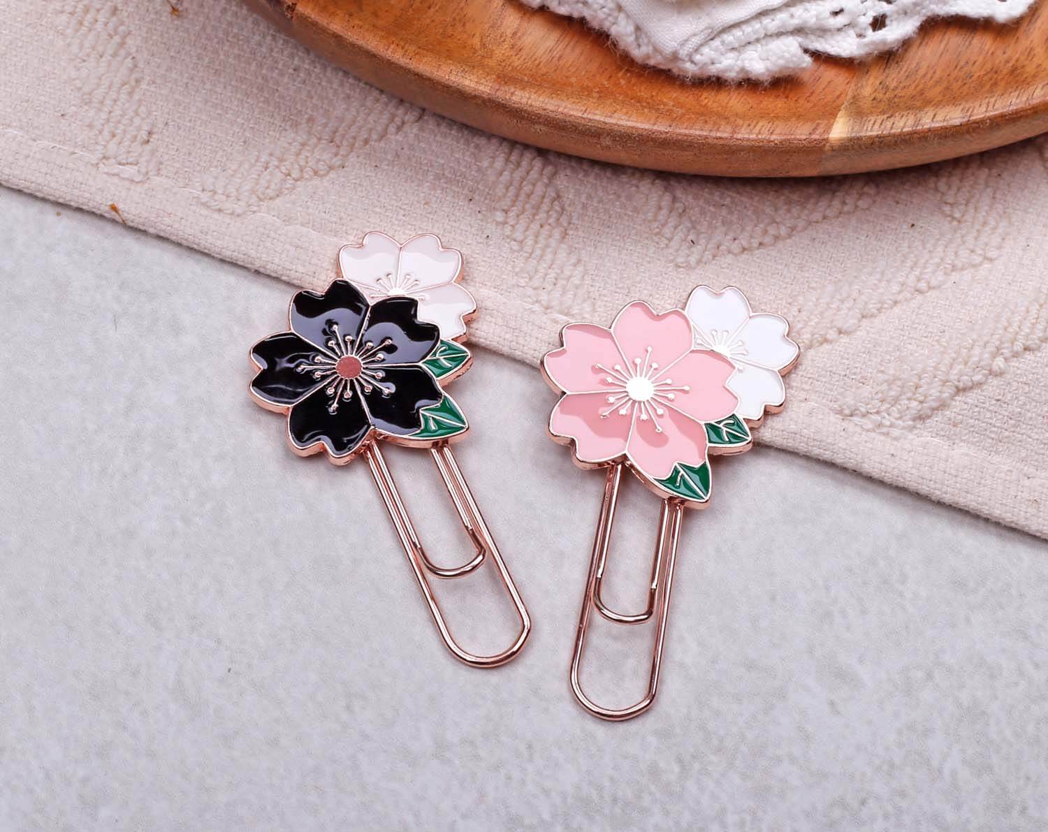 Set Of Flower Paper Clips - Enamel featuring black and pink floral designs for stylish organization.