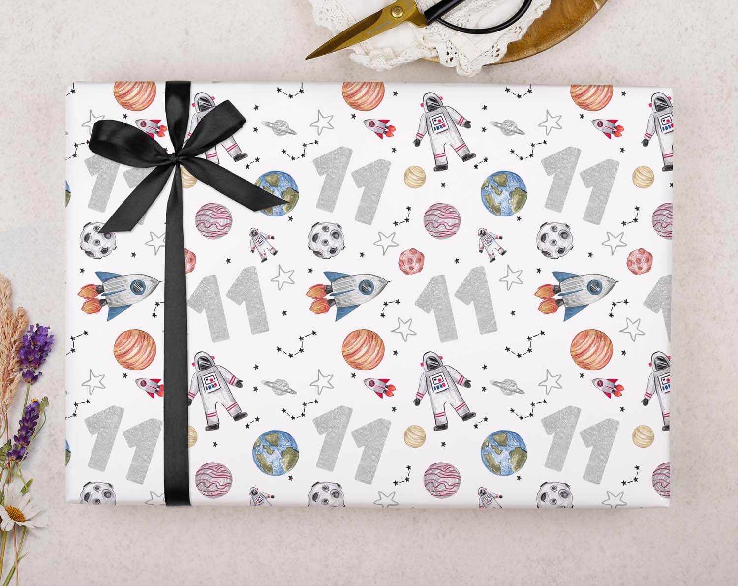 Space 11th Birthday Wrapping Paper featuring rockets, planets, and soccer balls, perfect for a child's birthday gift.