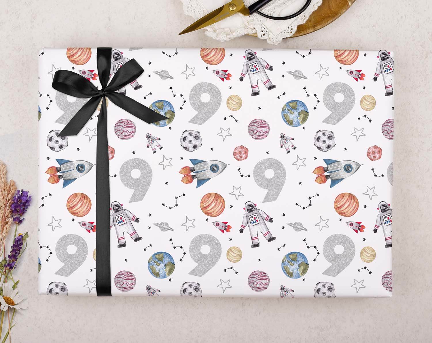 Space 9th Birthday Wrapping Paper featuring rockets, planets, and stars, perfect for an out of this world birthday.