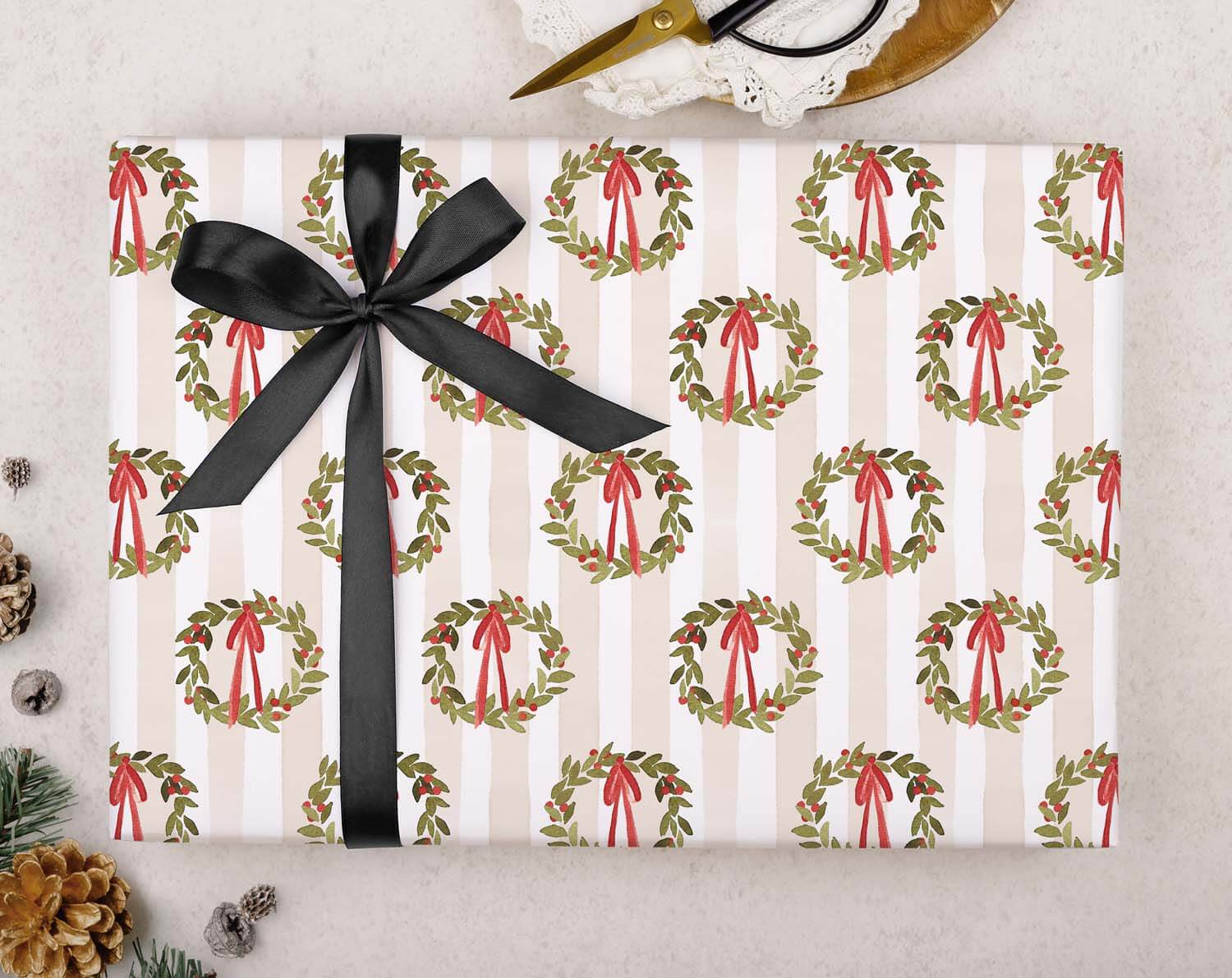 Traditional Wreath Christmas Wrapping Paper with holly wreaths and red bows on neutral striped background.