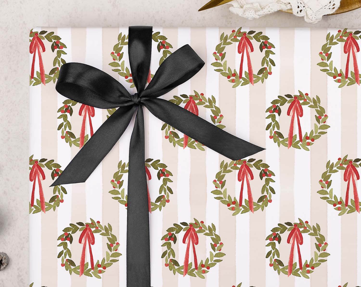 Traditional Wreath Christmas Wrapping Paper with holly wreath pattern and black ribbon bow.